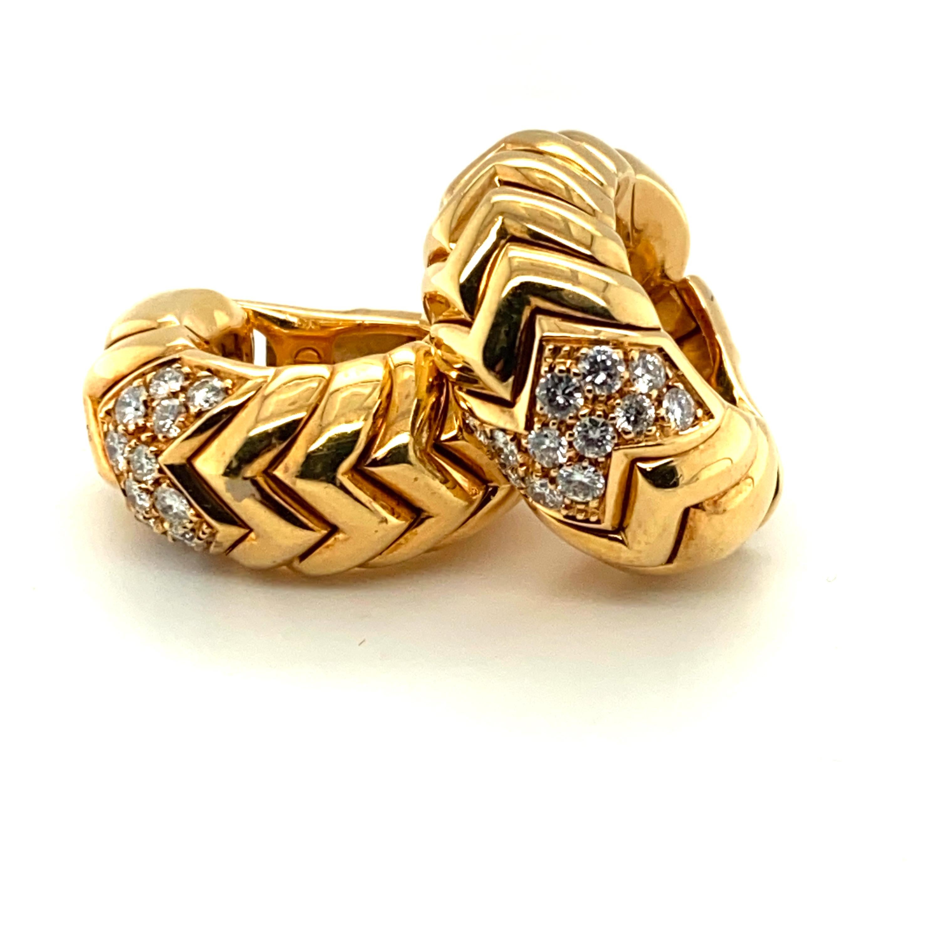 A pair of Bulgari's iconic interlocking chevron-patterned Spiga earrings featuring 24 diamonds totaling approximately .75ct.
This model originally retailed for approximately $8,900.

Signed, Hallmarked, Numbered, stamped 750