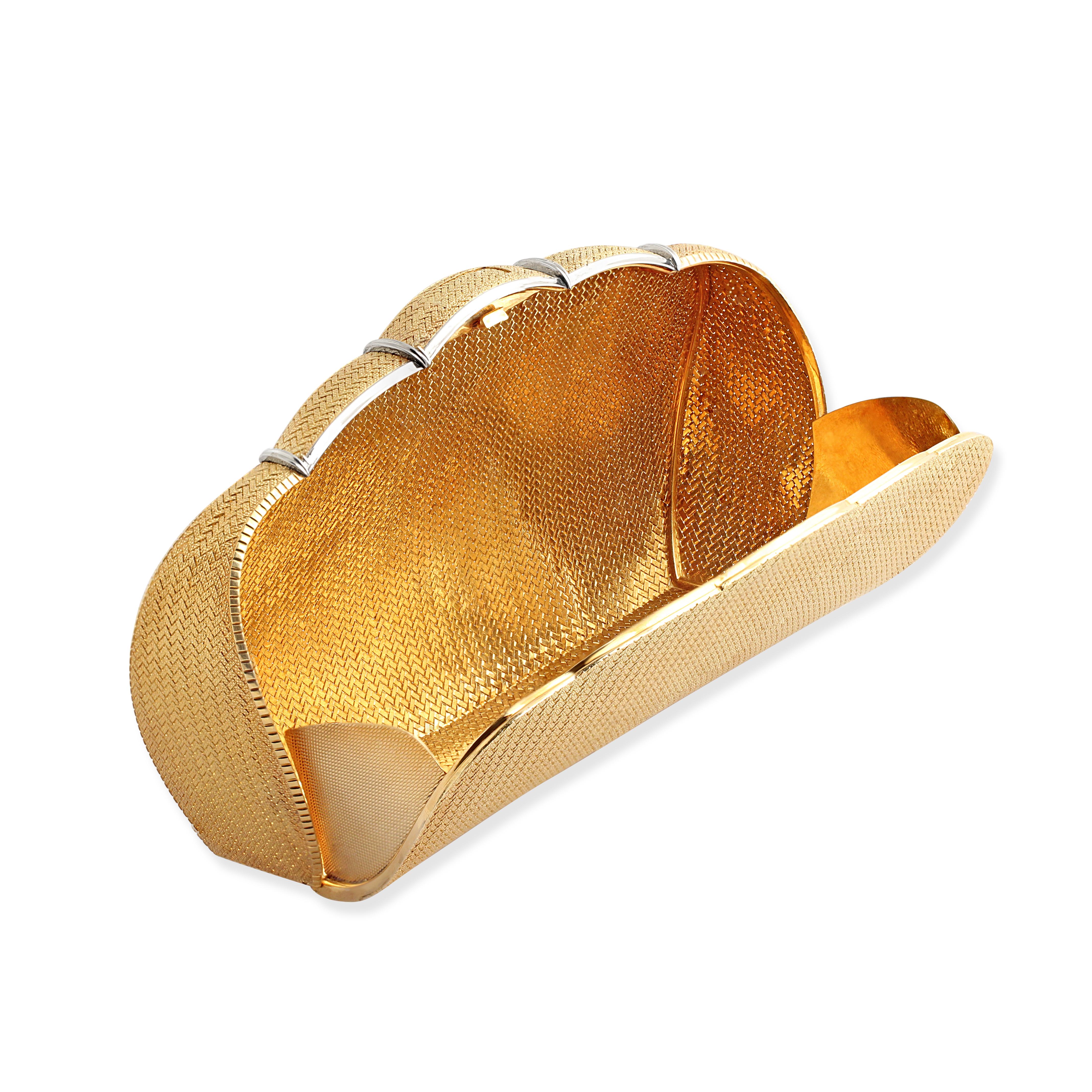 A vintage gold clutch bag by Bulgari with a scalloped edge. Crafted from woven 18k yellow gold with a discreet push clasp. Weight = 344.40gr. Circa 1970s. 17.5cm x 10cm (at widest and tallest points)

$57,500