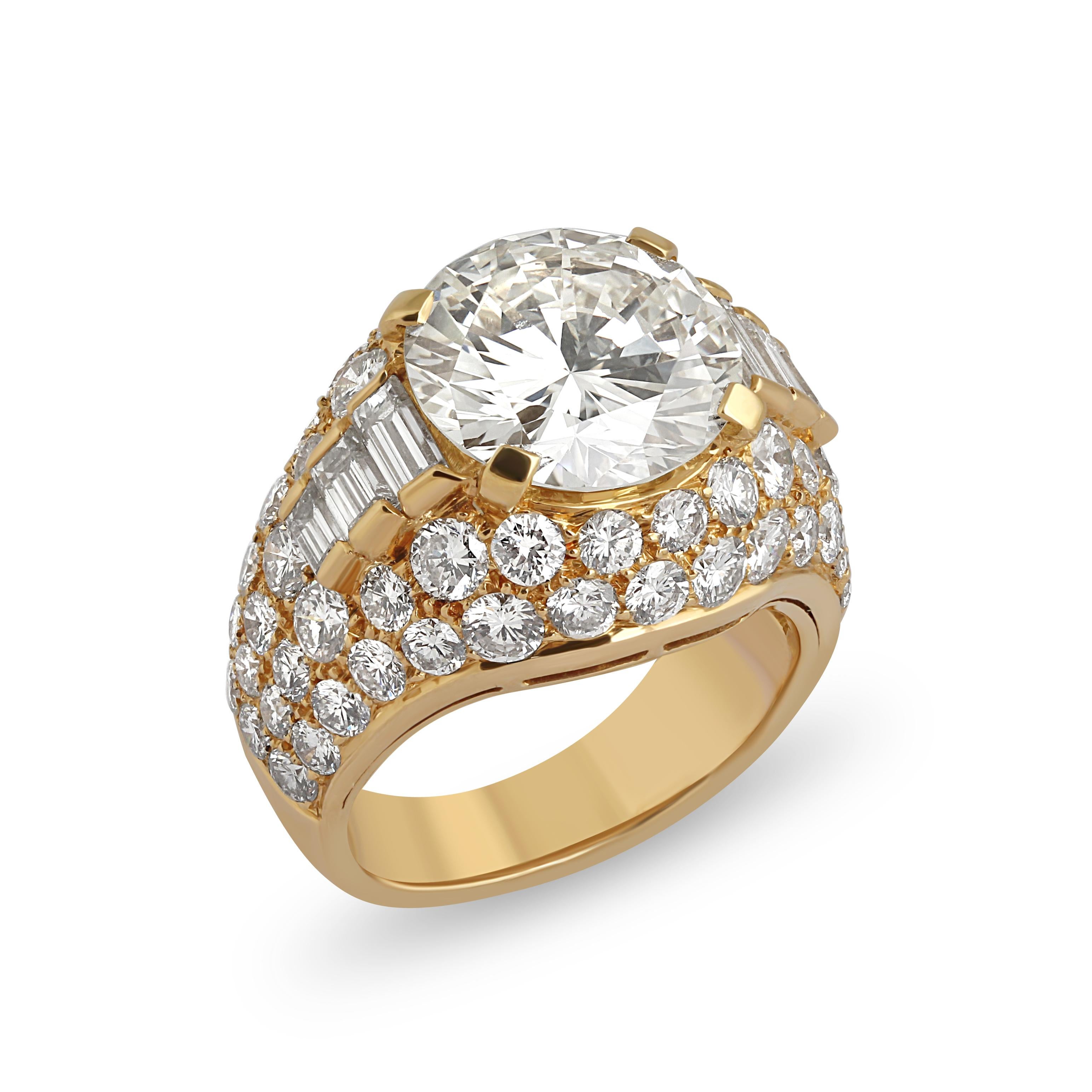A gold and diamond trombino ring by Bulgari. Set at the centre with a 4.64 carat brilliant cut diamond surrounded with baguettes on the shoulders in a pavé diamond 18k gold mount. Centre stone colour = K, Clarity = VVS1. The centre diamond is