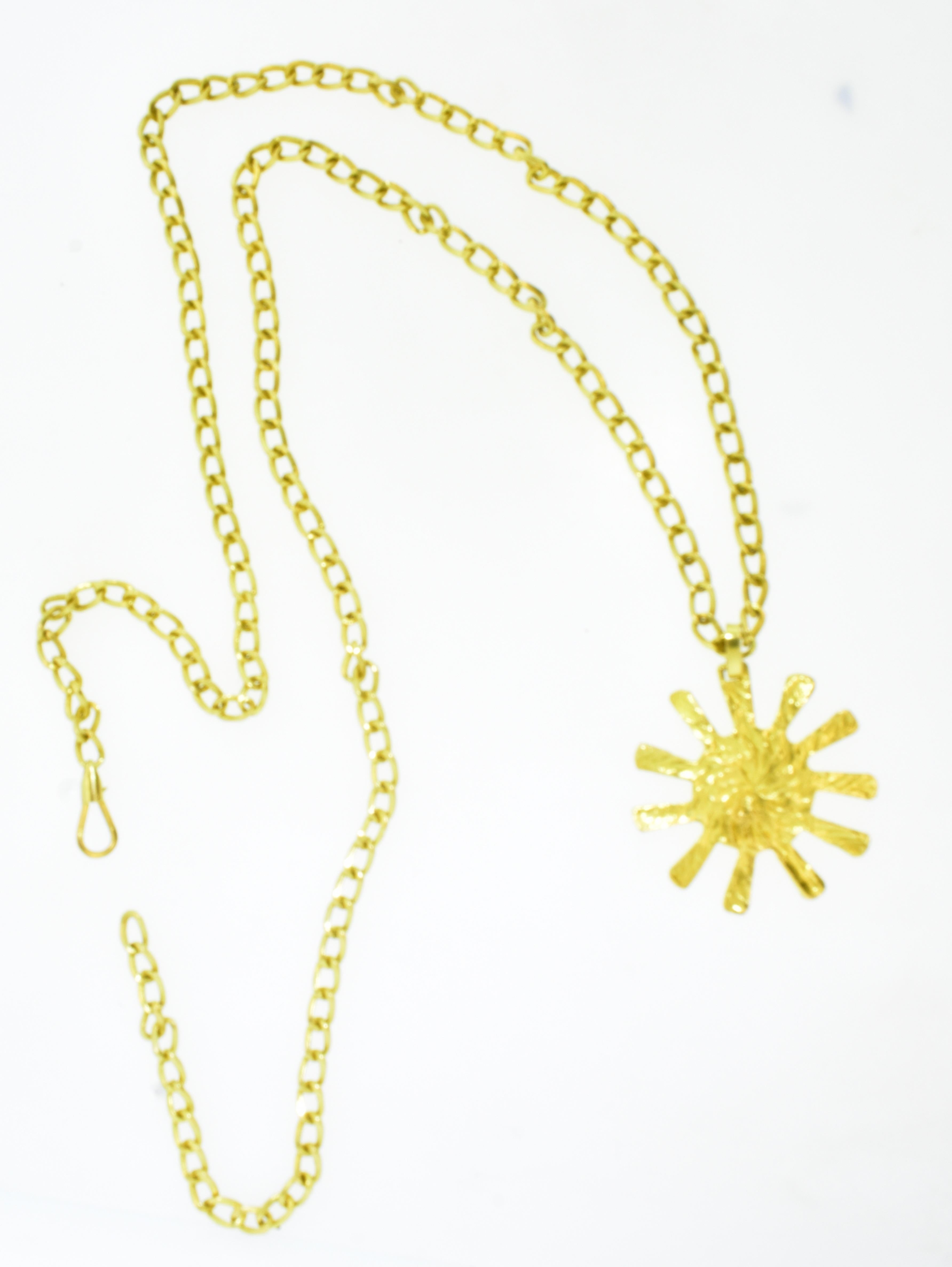 18K chain and sun pendant by Bvlgari, Italy, c. 1990.  This heavy long chain is 36 inches and terminates with Bvlgari's sun motif pendant which is 2.25 inches long.  The necklace weighs 108.63 grams and is signed on the clasp.  This is a vintage