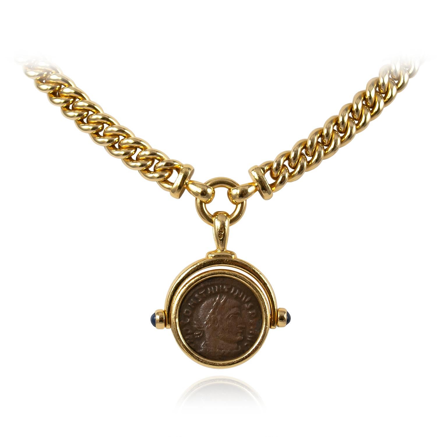 This vintage necklace carries on the Bulgari coin tradition in 18K Yellow Gold; adorned with sapphire cabochons and an Italian coin center of Constantine Magno (307 - 337 BC). 

HISTORY OF THE BULGARI COIN THEME: 
In the 1960s, Bulgari developed a