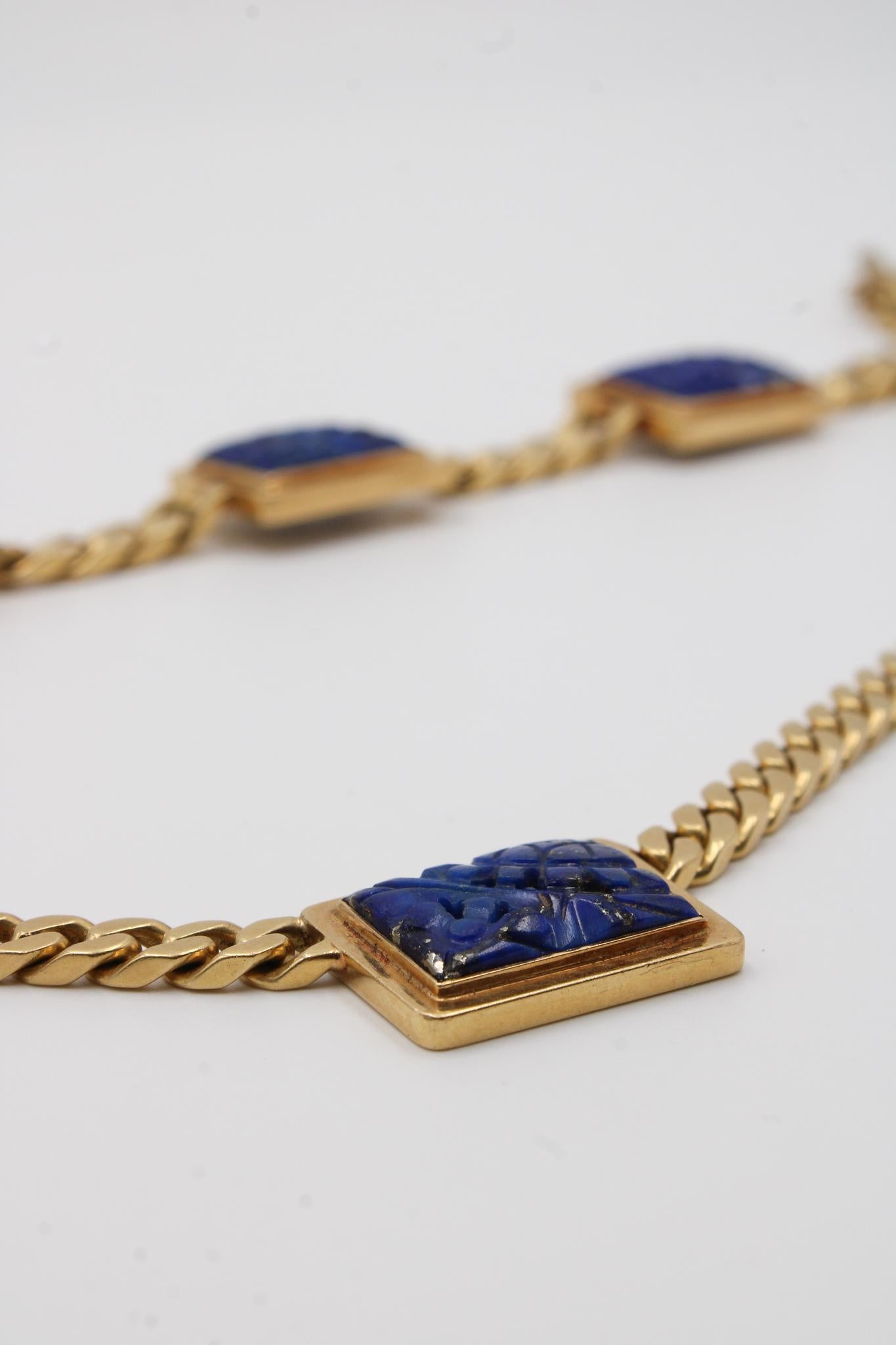 A rare and historically important parure by Bulgari, dating back to the 1930s-1940s, composed of a matching necklace and bracelet in 18-karat yellow gold. Both pieces are adorned with rectangular plaques of deep blue lapis lazuli, finely carved with