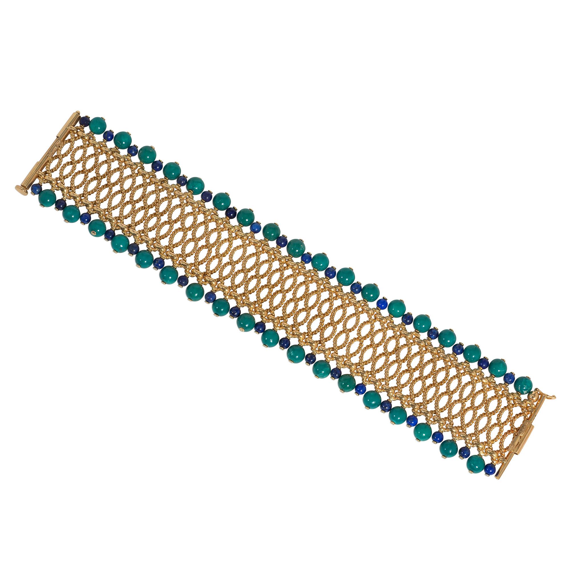 A Mid-Century gold, lapis, and turquoise bracelet comprised of rows of rope twist gold wirework with alternating lapis and turquoise bead terminals, in 18k. Bulgari, made in France.

Matching necklace available for $35,000 (See photos)