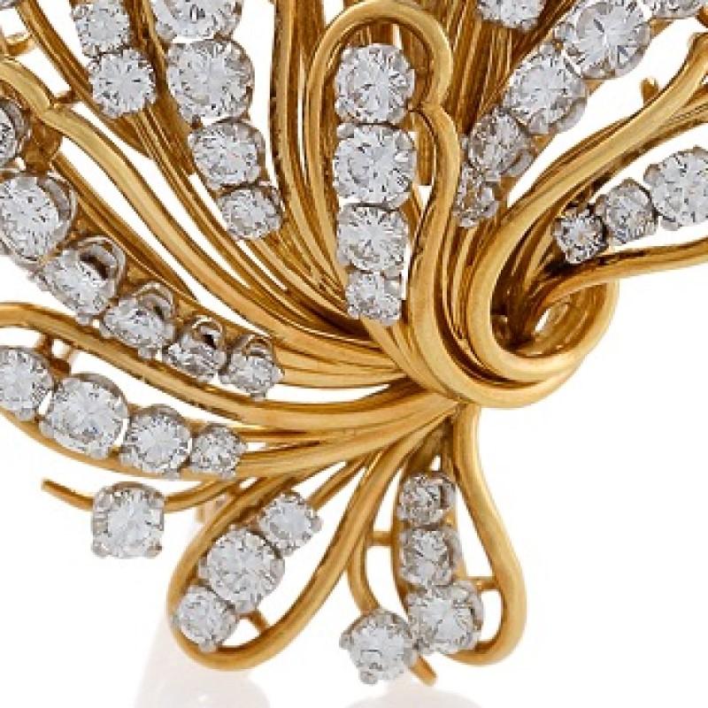 This gold wire-work and diamond bouquet brooch was designed in the 1960s by Bulgari Rome. Designed with a free and exuberant hand, the brooch’s shaped petals are set with curving graduated lines of round brilliant-cut diamonds set in platinum. The