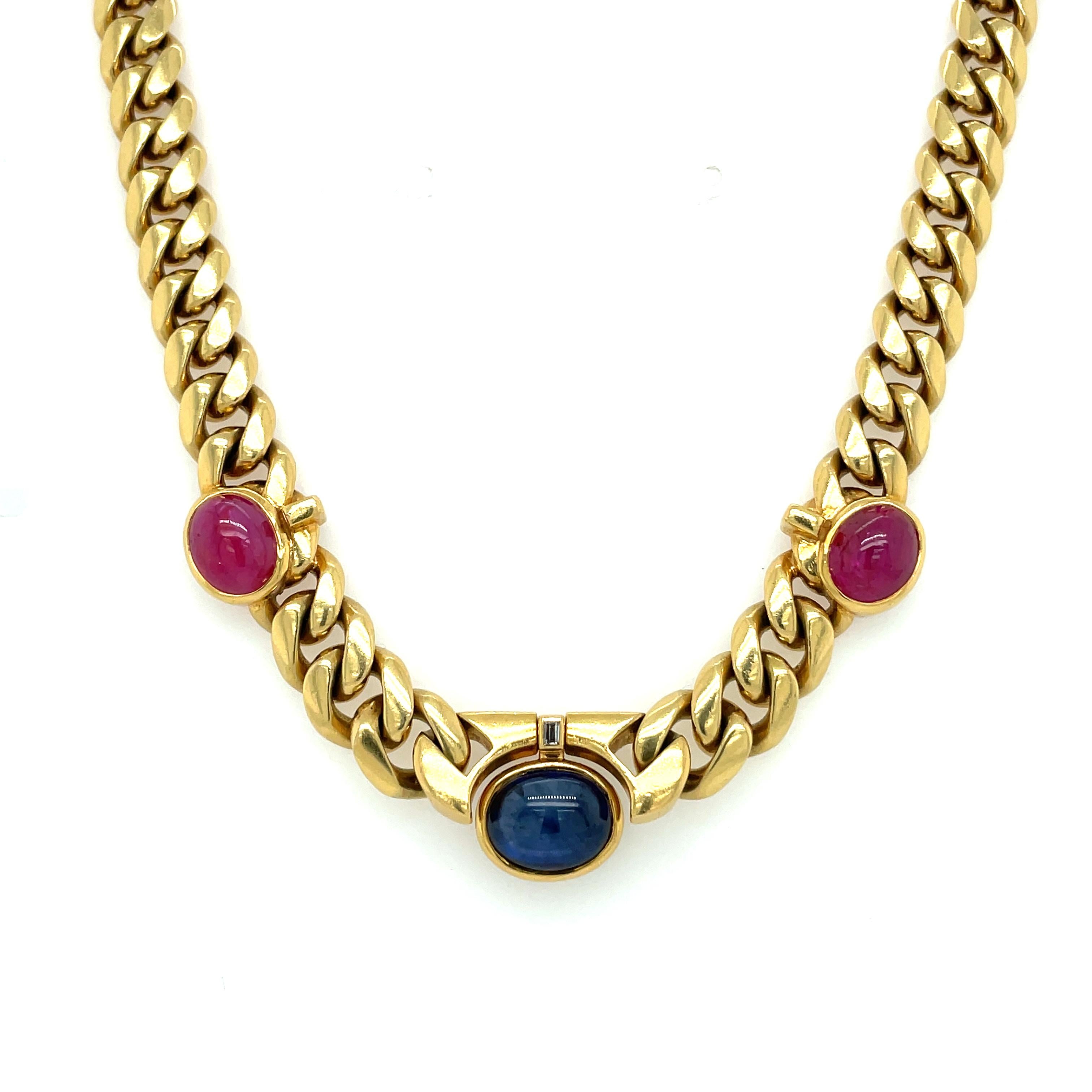 Designed as curb link chain featuring three stations featuring oval shaped cabochons. Consisting of two Natural unheated certified Ruby and one large certified Sapphire adorned by a baguette cut diamond. Made in France 1970

Ruby: 5 total