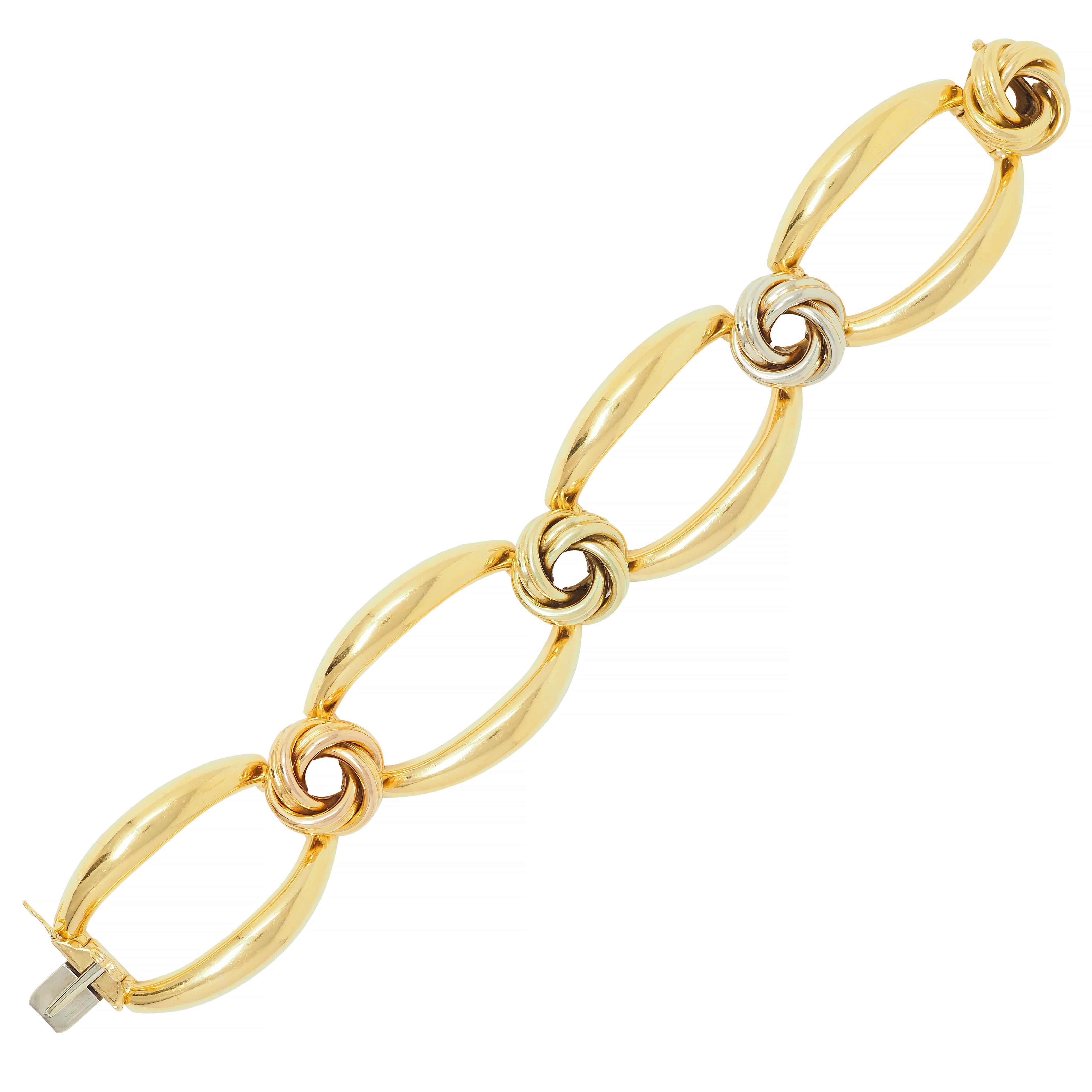 Comprised of large hinged oval-shaped yellow gold links 
Alternating with dimensional twisted knot links 
Yellow, rose, white, and green gold in color
Links are slightly curved for comfort 
Completed by concealed clasp closure
With figure eight