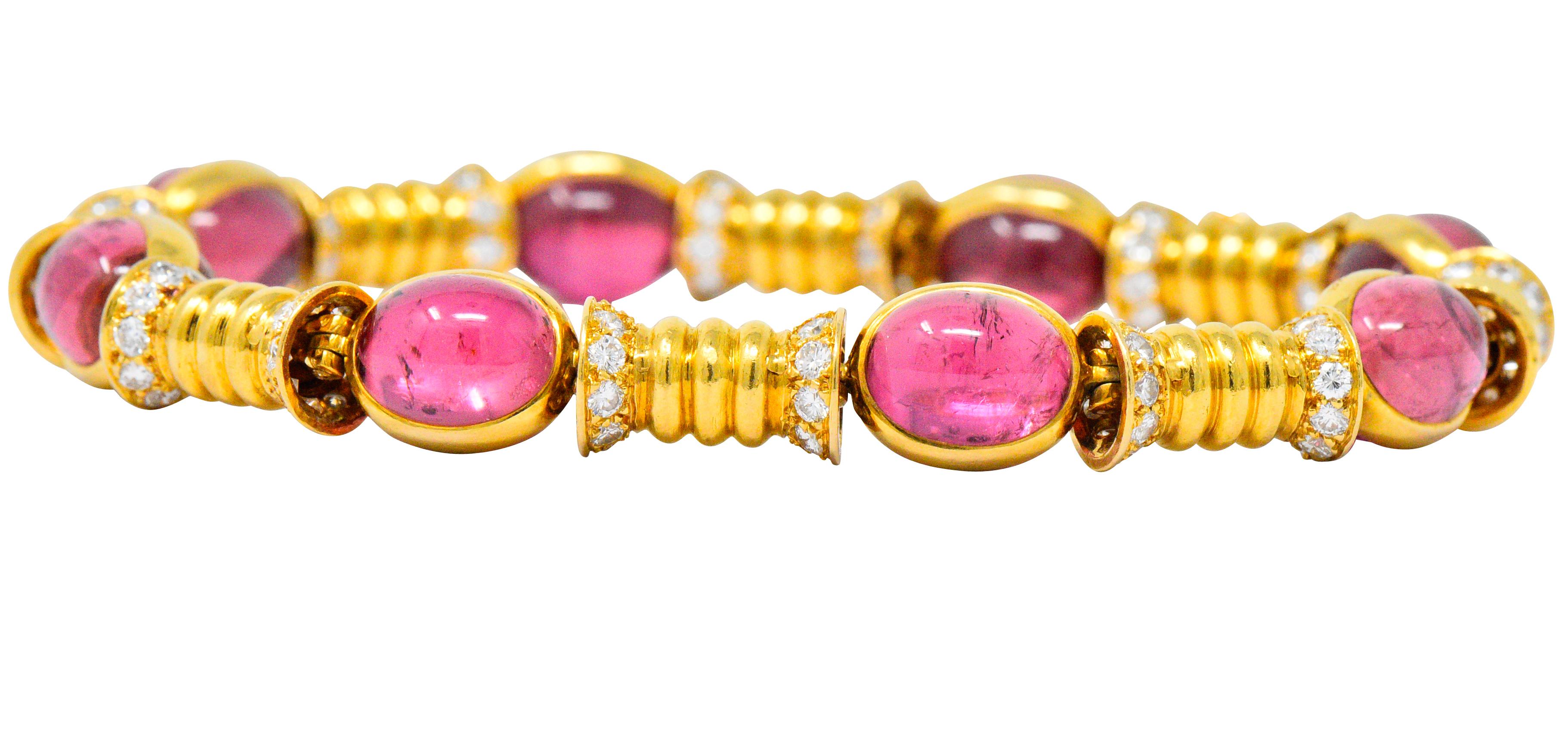 Featuring 16 oval cabochon pink tourmalines, set bottom to bottom and wrapped together with 18k gold, bright bubblegum pink and very well matched

With fluted gold spacer links accented with round brilliant cut diamonds

Total diamond weight