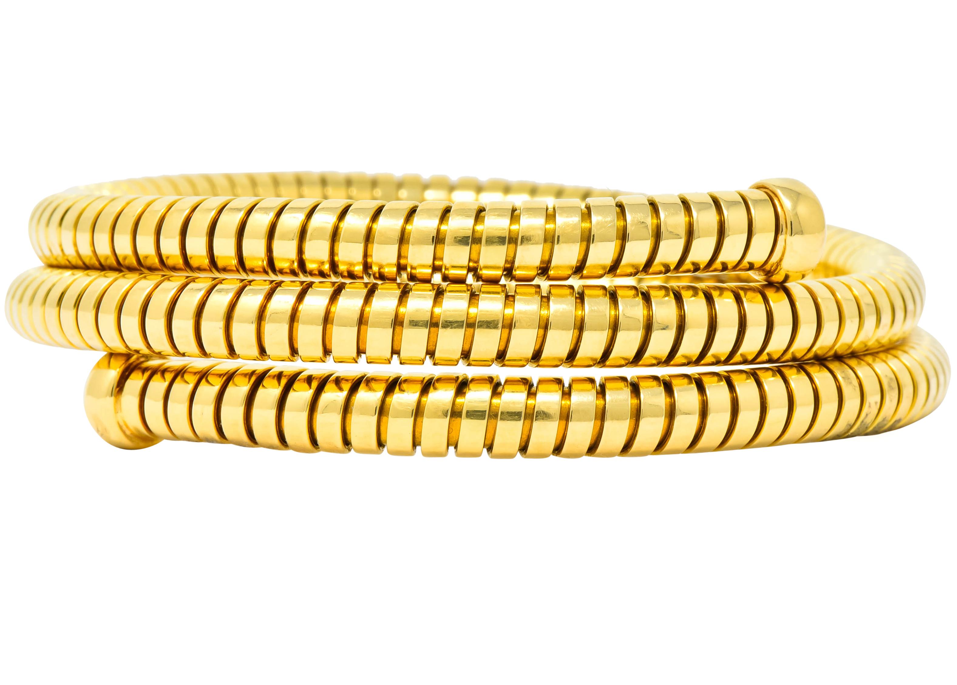 Bangle style bracelet of high polished 18 karat gold with two round terminals

With iconic Tubogas construction allowing for flex fit

Fully marked Bvlgari and stamped 'Made in Italy' as well as 750 for 18 karat gold and Italian assay marks

Circa