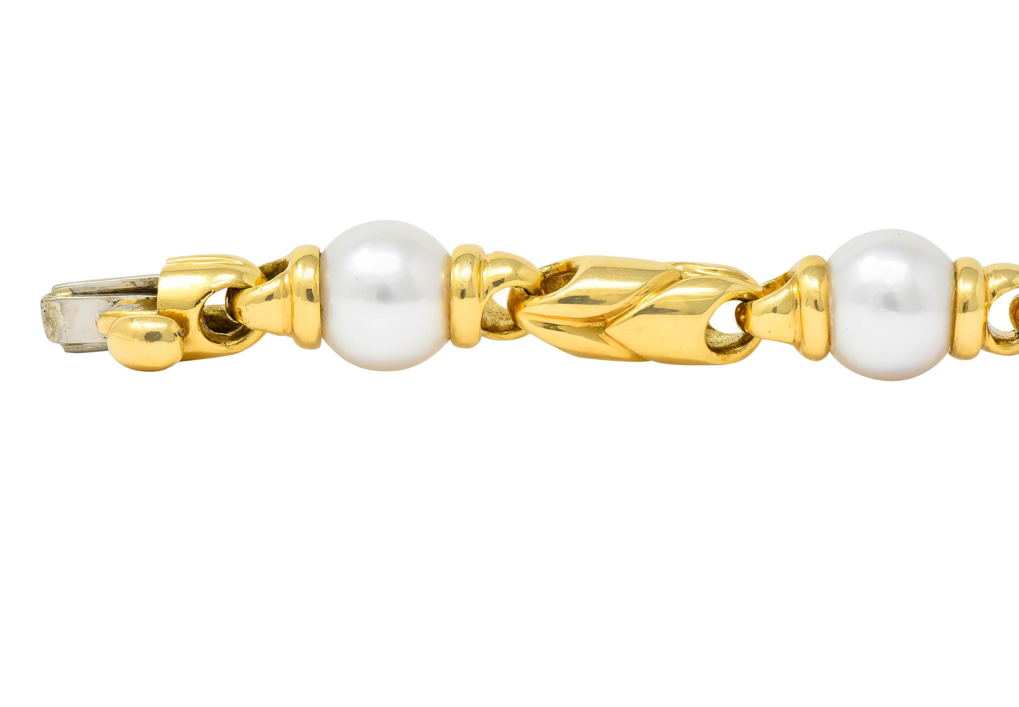 Link style bracelet comprised of cultured pearls and deeply grooved  polished gold links

Cultured pearls measure approximately 8.7 mm, cream body color with strong rosé overtones and excellent luster  

Completed by concealed safety clasp with