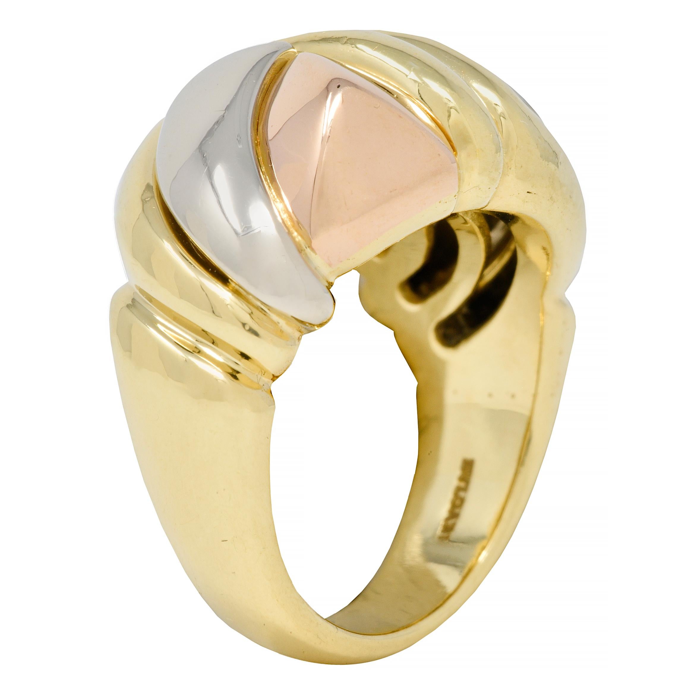 Designed as a domed form comprised of segmented triangular forms 
Rose gold form is faceted and white gold form is curved
Bisected by a fluted gold twist motif surround 
With high polish finish
Stamped with Italian assay marks for 18 karat