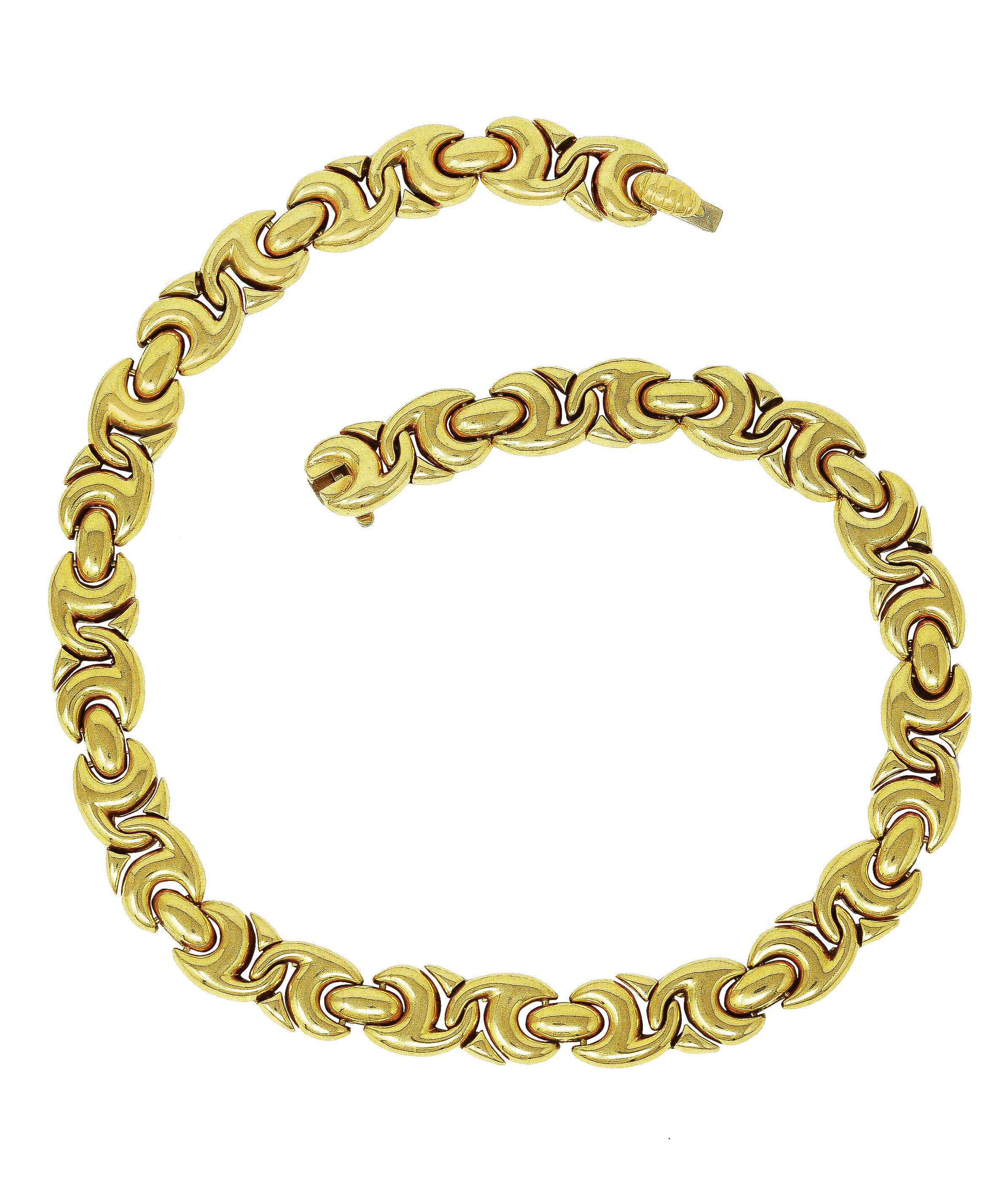 Necklace features puffy stylized links with interlocking twist motif. With high polish finish. Completed by press release closure. Stamped 750 with Italian assay marks for 18 karat gold. Numbered and fully signed for Bvlgari. Circa: 1980's from the