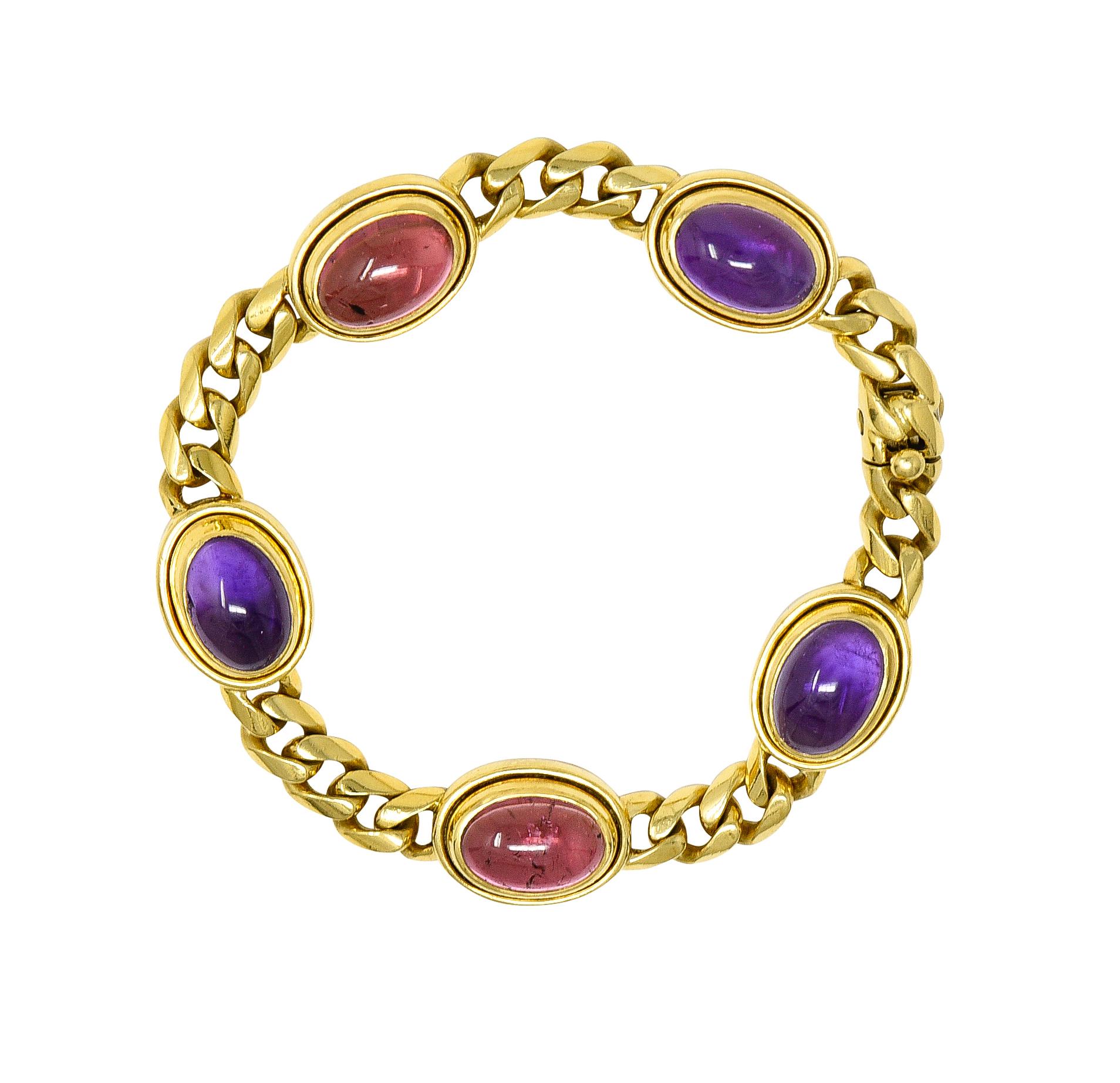 Designed as a curb link chain alternating with bezel set gemstone stations
Set with oval-shaped amethyst and tourmaline cabochons measuring 8.0 x 12.0 mm
Transparent medium purple and medium pink in color, respectively
Completed by concealed clasp