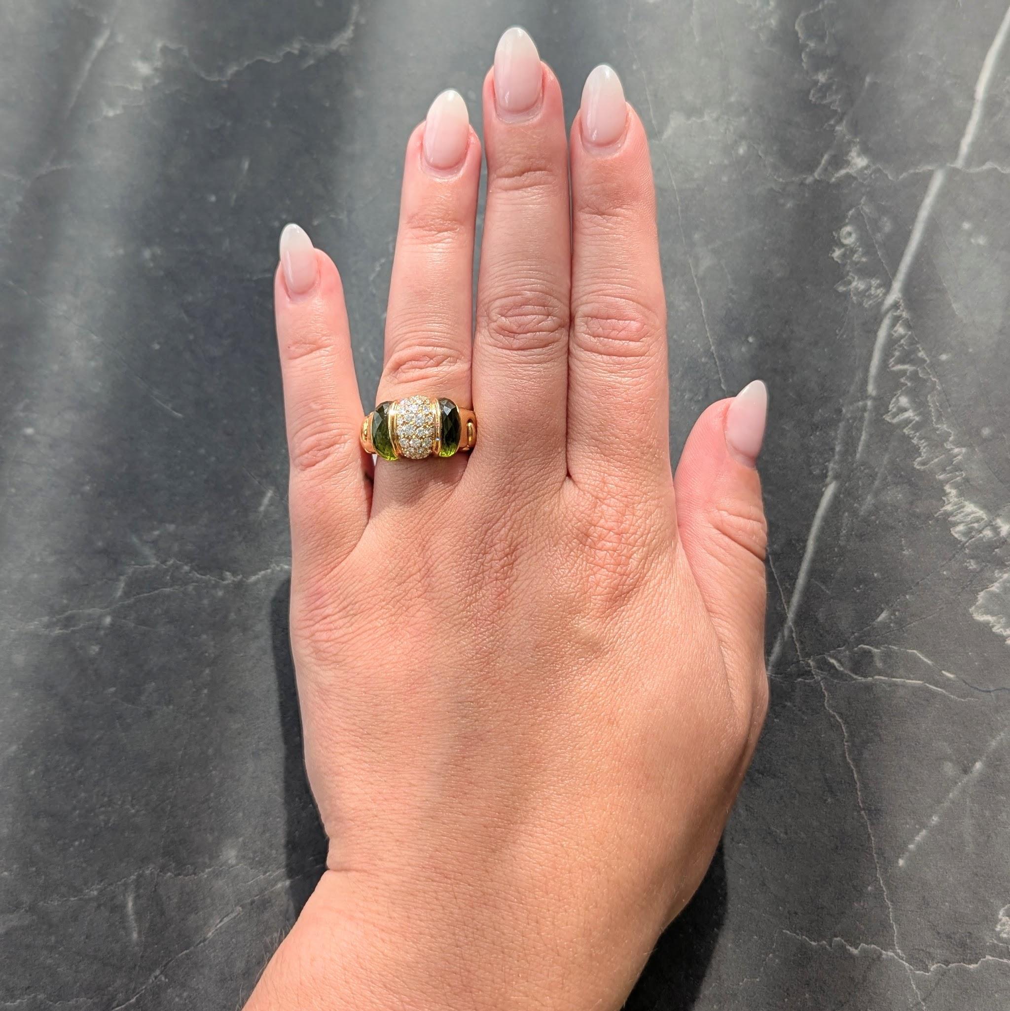 Designed as a domed form pavé set with round brilliant cut diamonds
Weighing approximately 1.16 carats total - G color with VS2 clarity
Flanked by carved faceted peridot inlay measuring 10.5 x 3.5 mm
Transparent medium yellowish green - flanked by