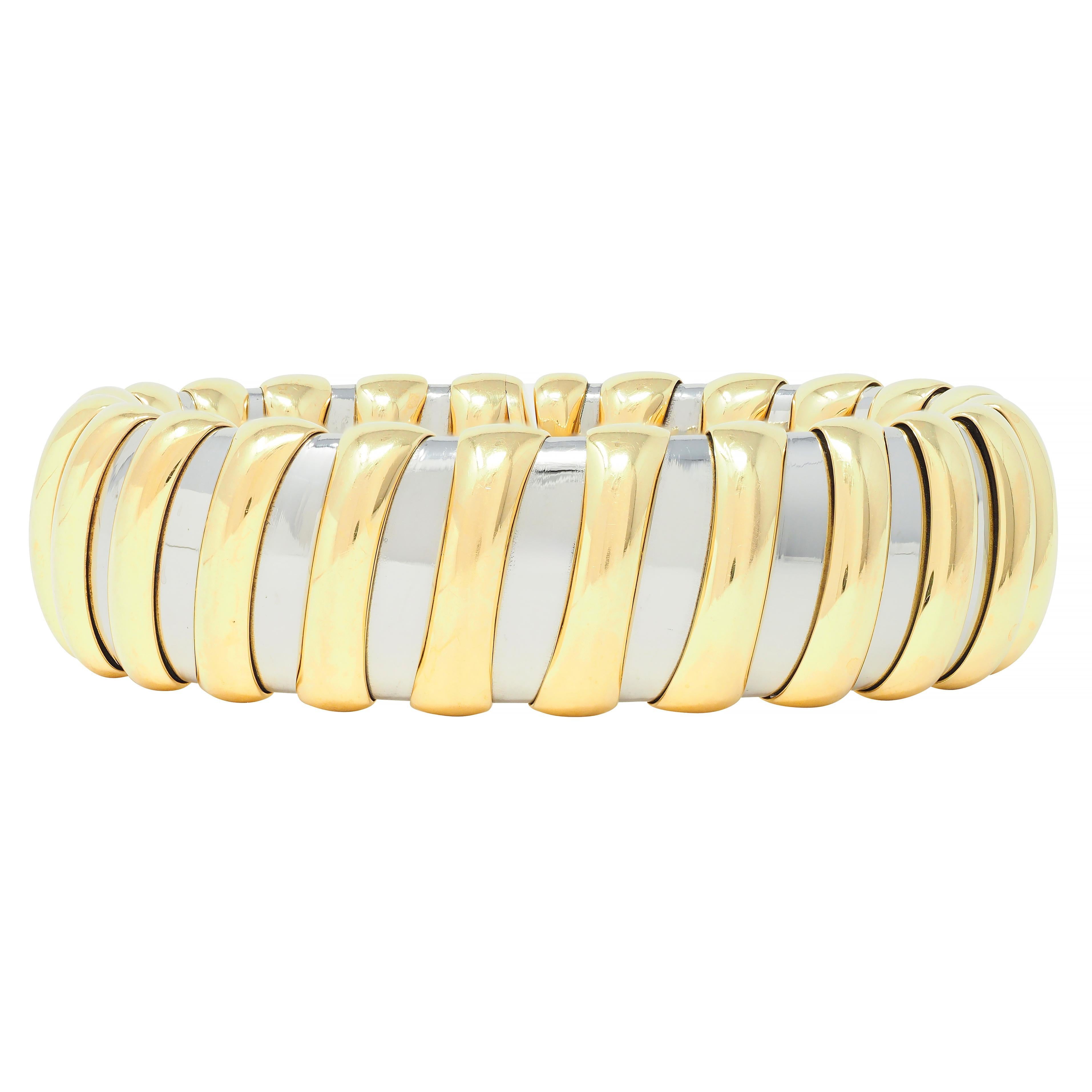 Comprised of alternating tubogas segments of gold and stainless steel 
Gold segments are raised with rounded surface - high polished
Completed by gold flush open terminals 
Stamped with Italian assay marks for 18 karat gold and stainless steel