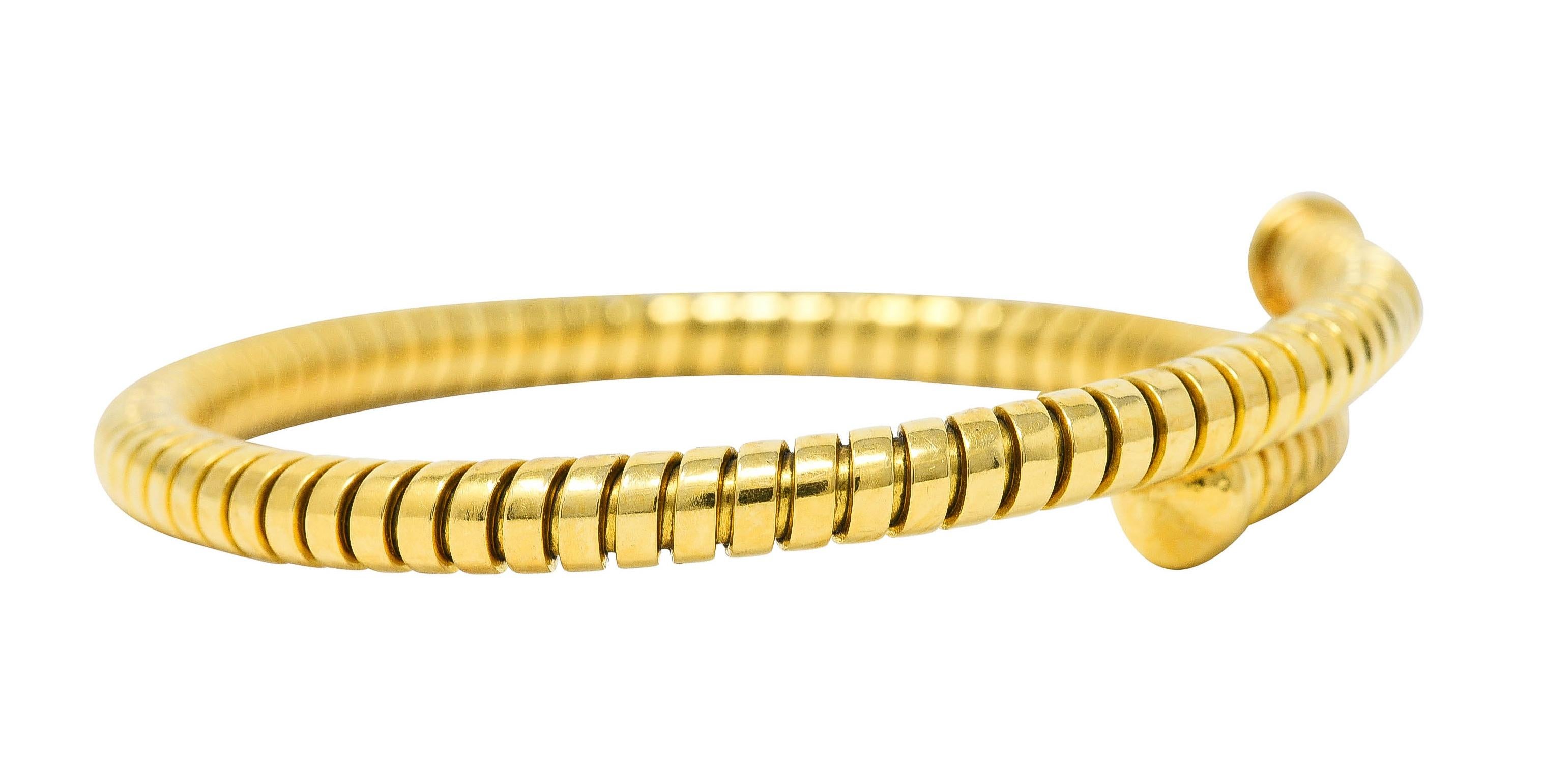 Designed as a rounded tubogas with grooved gold segments. Flexible with rounded nail head style terminals. Completed by high polished finish. Stamped 750 with Italian assay marks for 18 karat gold. Numbered and fully signed for Bvlgari, Made in