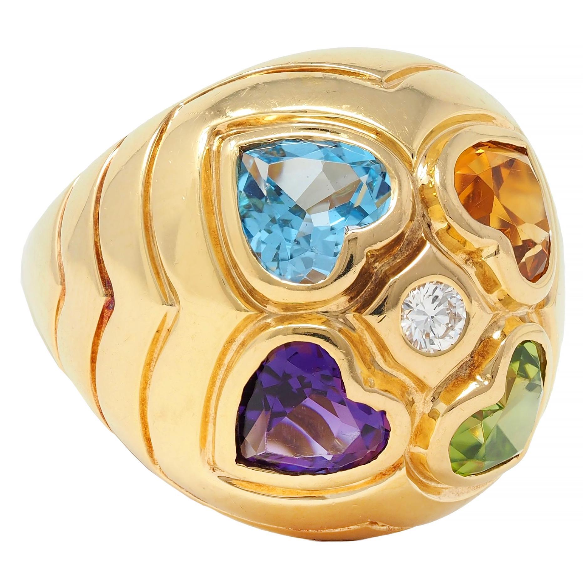 Designed as a domes form centering a quatrefoil motif comprised of hearts
Bezel set with heart cut amethyst, aquamarine, citrine, and peridot
Transparent light to medium purple, blue, orange, and green, respectively
Quatrefoil centers a flush set