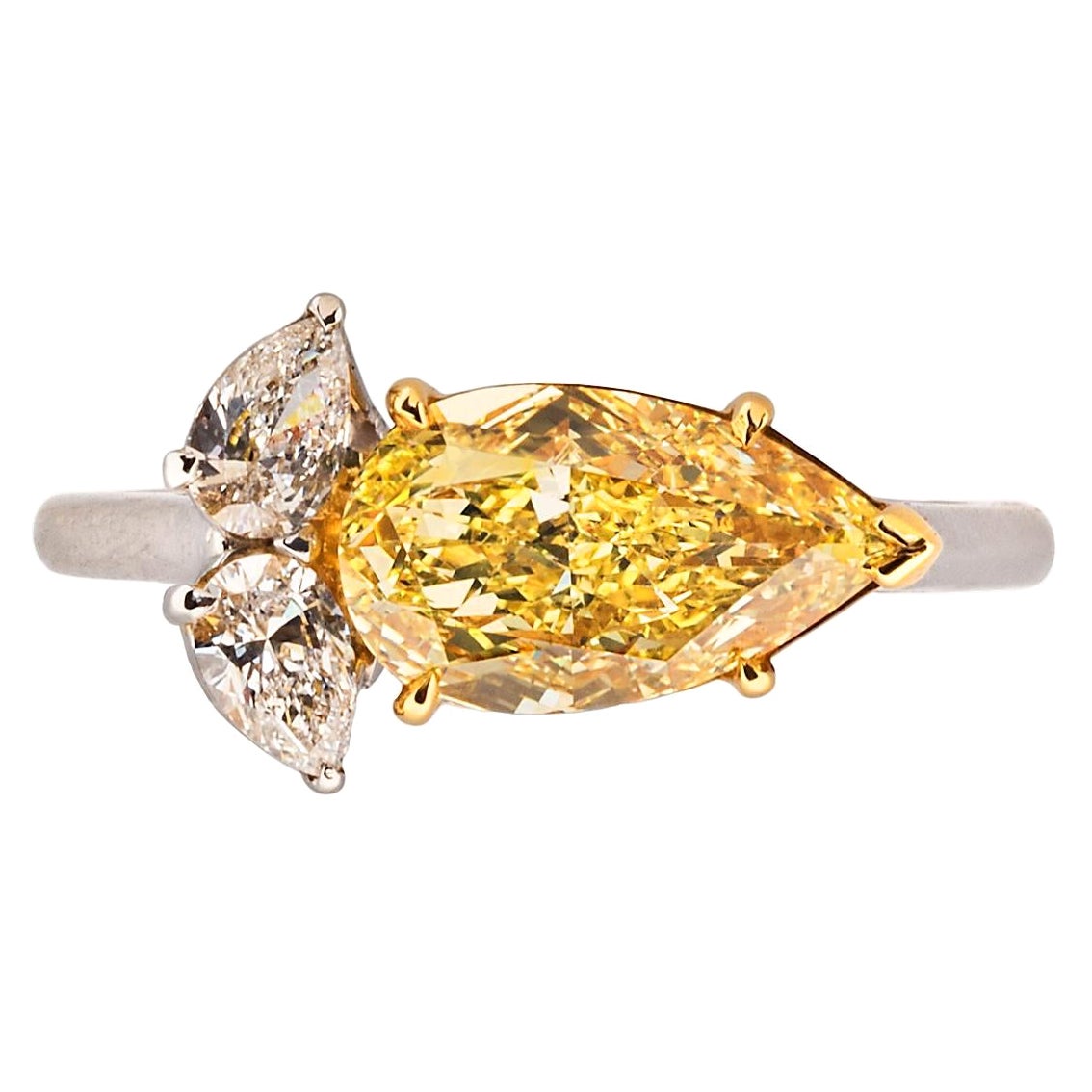 A 2.01 carat fancy intense yellow pear modified brilliant-cut diamond with two pear-shaped diamonds weighing approximately 0.25. – 0.35 carats, mounted in platinum and 18k yellow gold.  

Size 6-1/2, can be resized 
Accompanied by 2020 GIA report