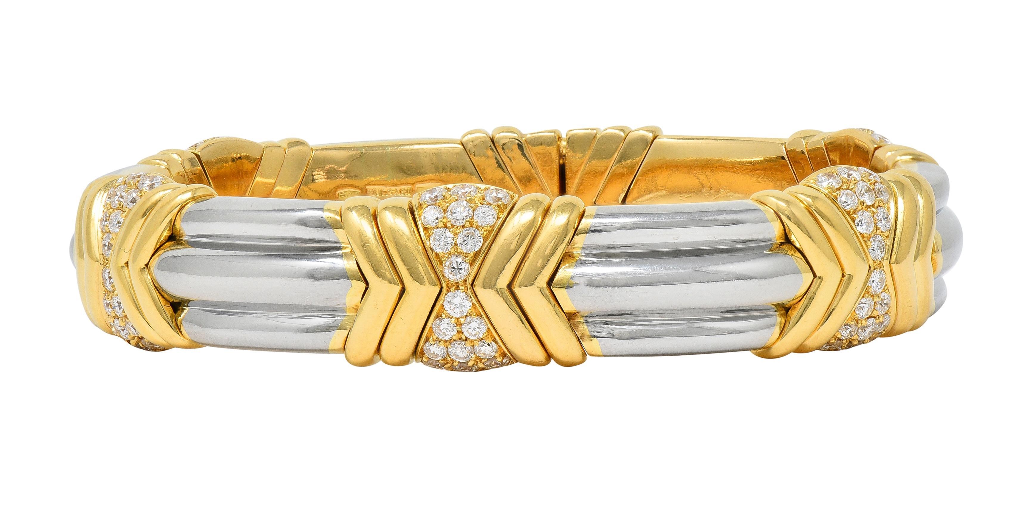 Comprised of segments of alternating ridged stainless steel and yellow gold stations 
Featuring a chevron motif with pavé set round brilliant cut diamond centers
Weighing approximately 2.60 carats total - G color with VS2 clarity 
With considerable
