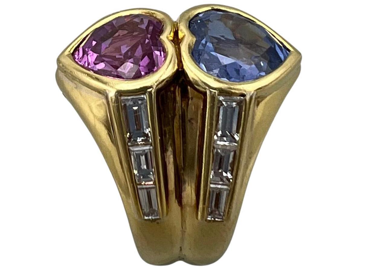 Product details:

The ring is made out of heart cut blue (no heat) and pink (heat) sapphire, accented with baguette diamonds on the sides and set in 18K yellow gold.

Hallmarks: BVLGARI, maker’s mark for Bulgari, Italian make’s mark, 750 for 18K