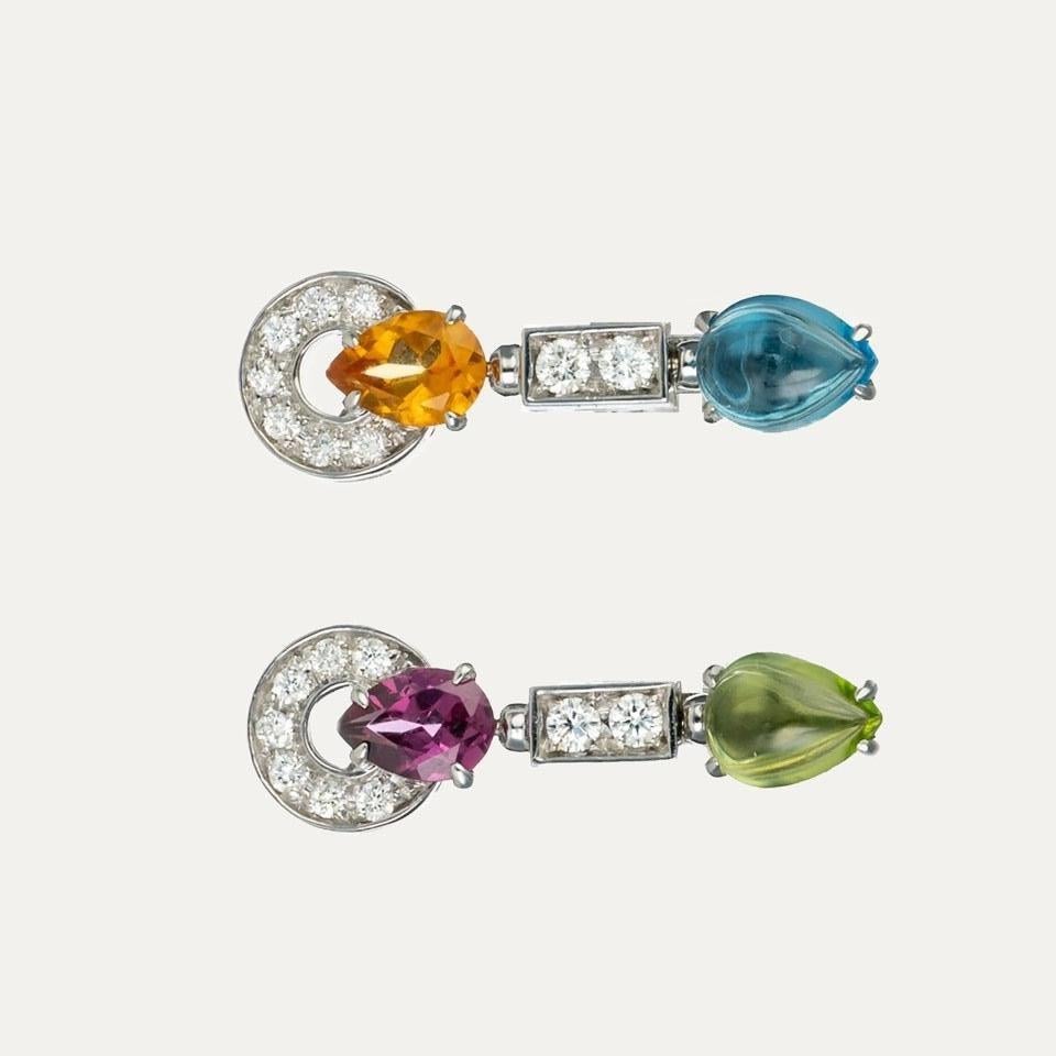 
Bulgari earrings in 18kt – 750‰ white gold, from the Allegra collection. Inspired by the joy and exuberance of life, set with 18 brilliant-cut diamonds, a teardrop cabochon citrine, a faceted teardrop tourmaline, a teardrop cabochon topaz, and a