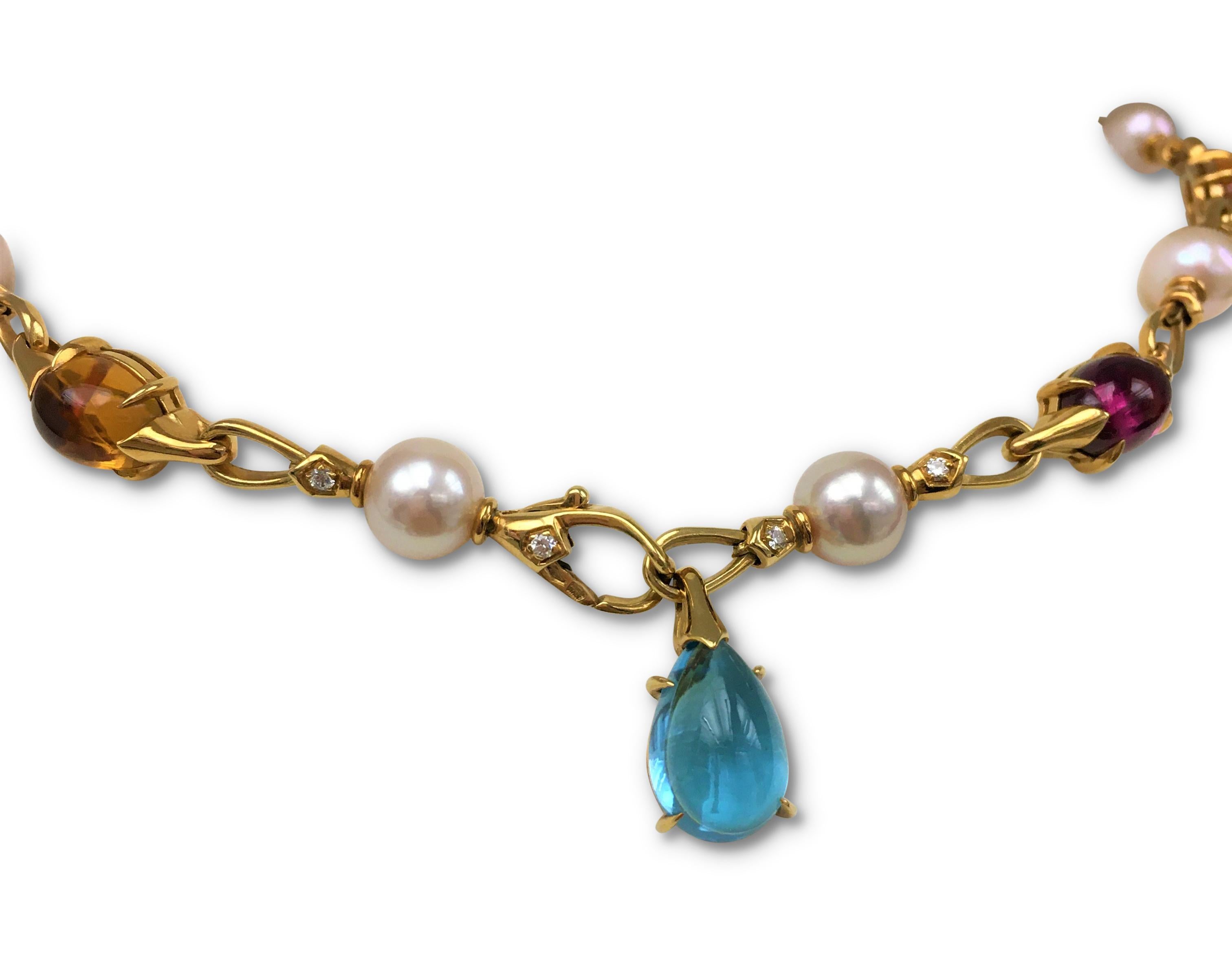 Authentic Bulgari Allegra necklace crafted in 18 karat yellow gold and set with cabochon-cut blue topaz, citrine, and tourmaline stones alternating with cultured pearls. The necklace links are accented with round brilliant cut diamonds weighing an