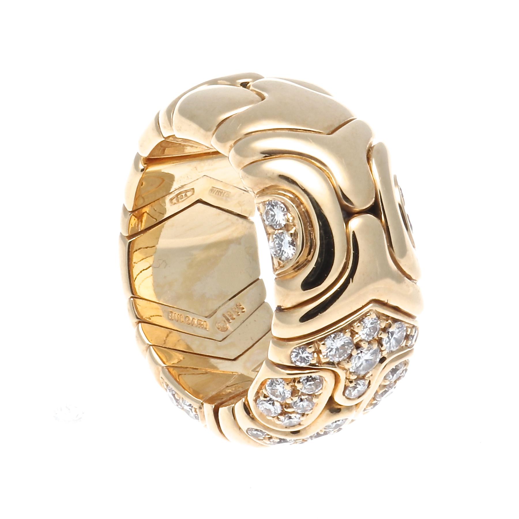 An uniquely abstract design put together by the futuristic Italian designer Bulgari. Featured in sections of glistening 18k yellow gold and colorless round cut dimaonds. Signed Bvlgari with serial number.

Ring size 5.

