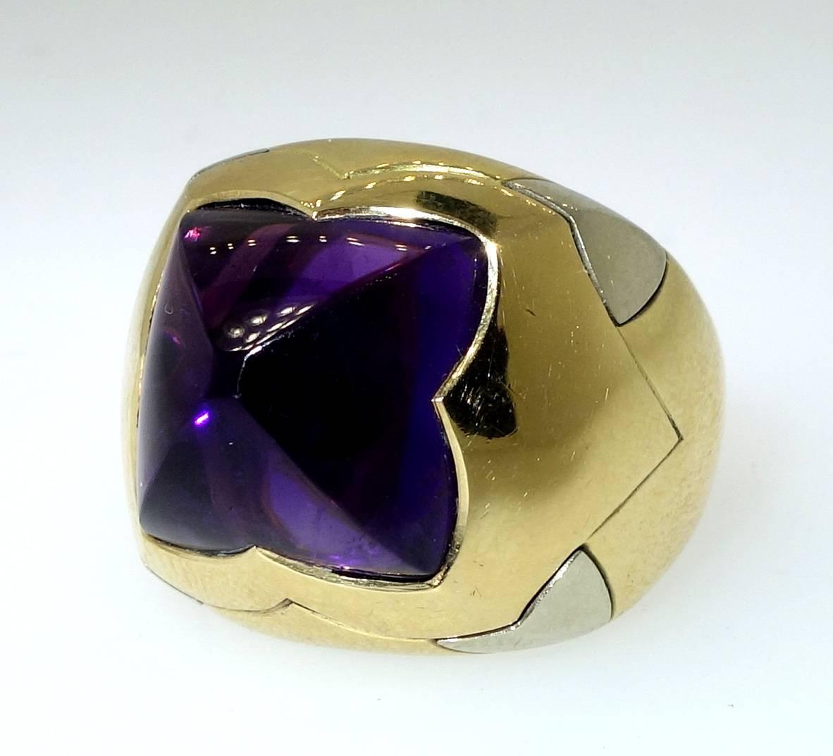 Fancy sugar loaf cut, approximately 8 ct., deep purple amethyst set in 18K yellow gold and accented with 18K white gold.  Now a size 6 and can be sized.  Signed and numbered Bulgari Italy, 750 for 18K.