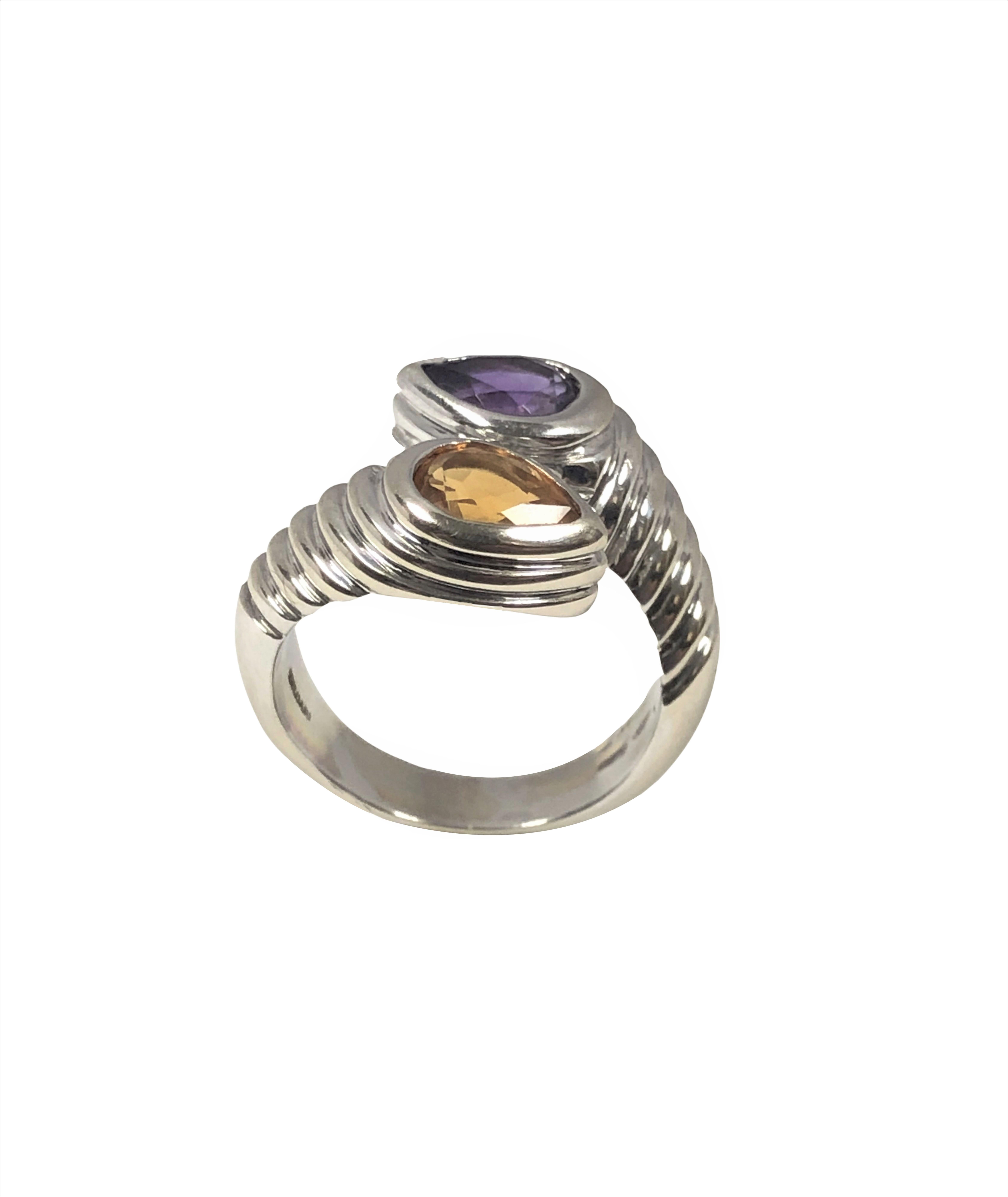 Circa 2016 Bulgari 18k White Gold Bypass Ring, measuring 5/8 inch across the top, having a ribbed design and set with a Pear shape Amethyst and a Pear shape Citrine each being approximately 1 Carat each. Finger size 6. Comes in original Bulgari