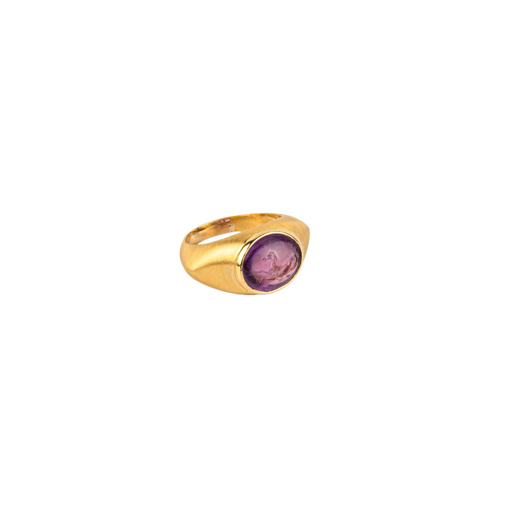 Bulgari Amethyst Intaglio ring in a brushed 18k gold with an image of a horse galloping. Made in Italy, circa 1970.