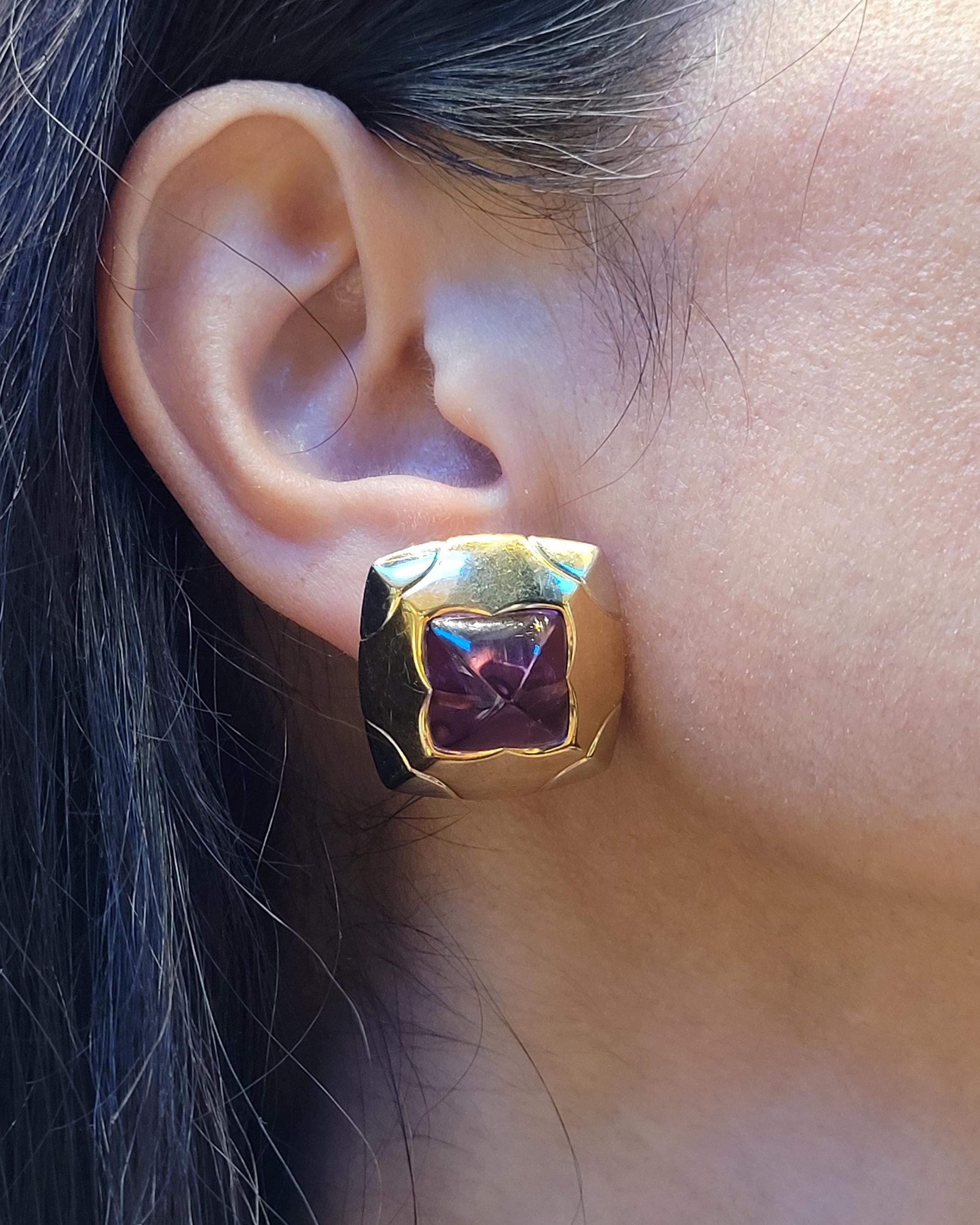 These superb Bulgari Pyramid Amethyst Button Earrings, made in Italy in the Contemporary Era, circa 2000s, are crafted in 18K yellow and white gold with a high-polished finish. Framing the stone is a geometric floral cutout, or Islamic stylized