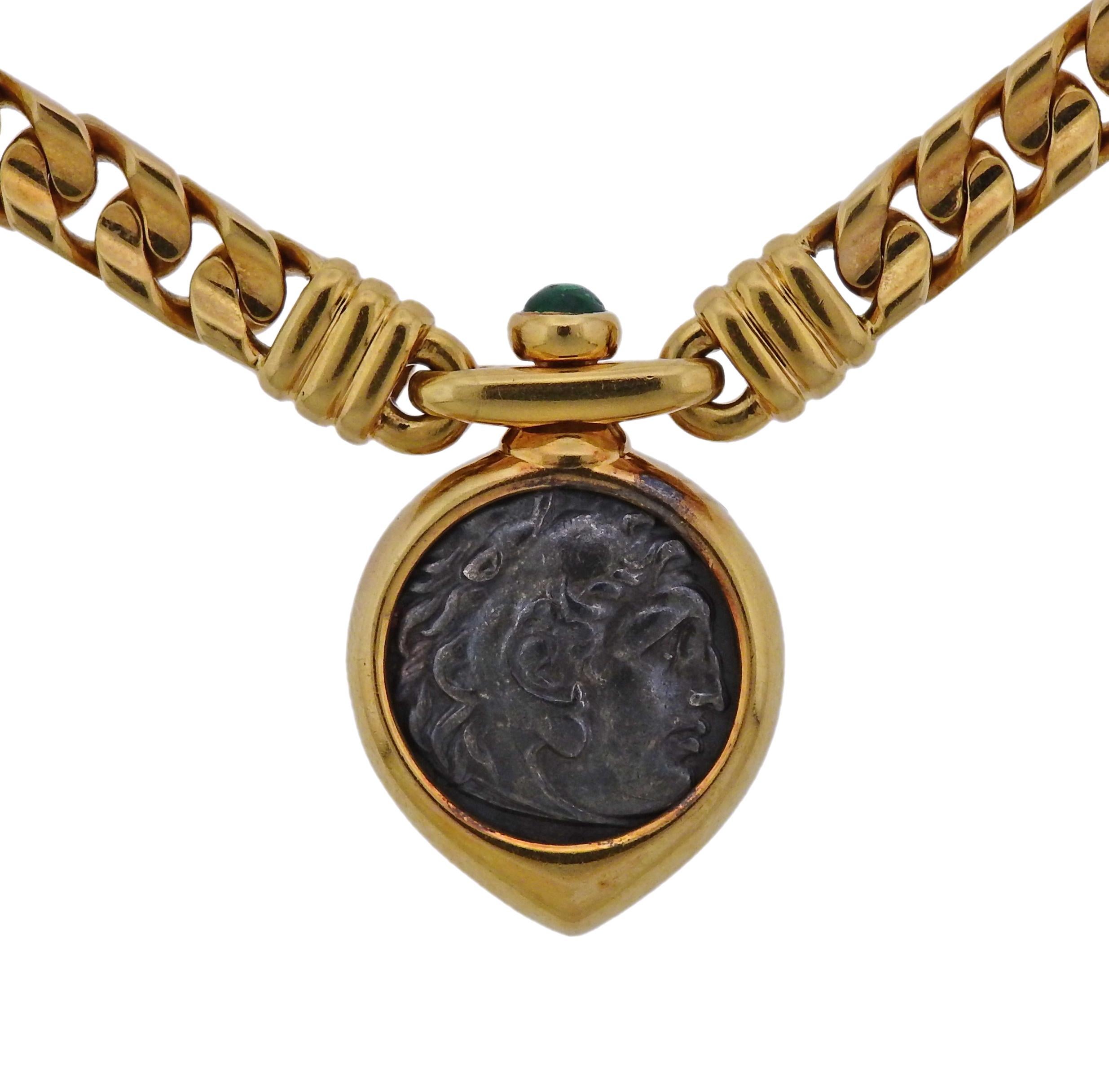 18k gold Monete necklace, crafted by Bvlgari, set with Alessandro Magno Dramma 16mm ancient coin, dated 336-323 A.C., set in bezel pendant, adorned with emerald cabochon . Necklace is 16