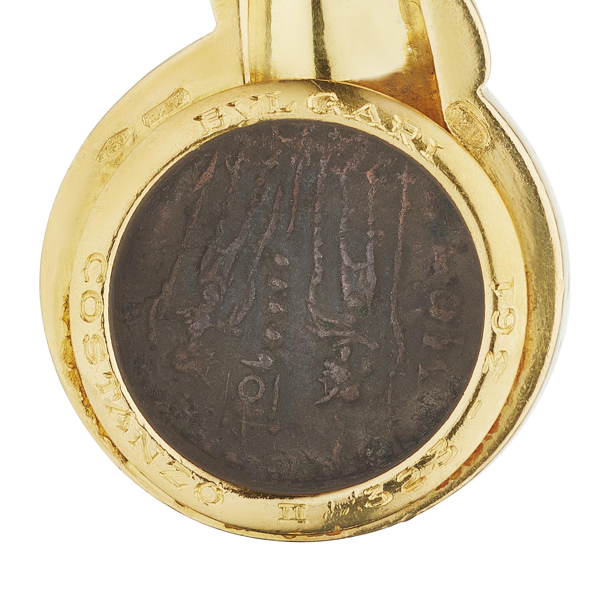 Wear a piece of the past with this Bulgari ancient bronze coin pendant necklace. With a twisted rope chain and rope framed ancient coin, this stylish pendant necklace reflects a gratefulness for the past. Circa 1980. Signed Bulgari. Stamped Costanzo