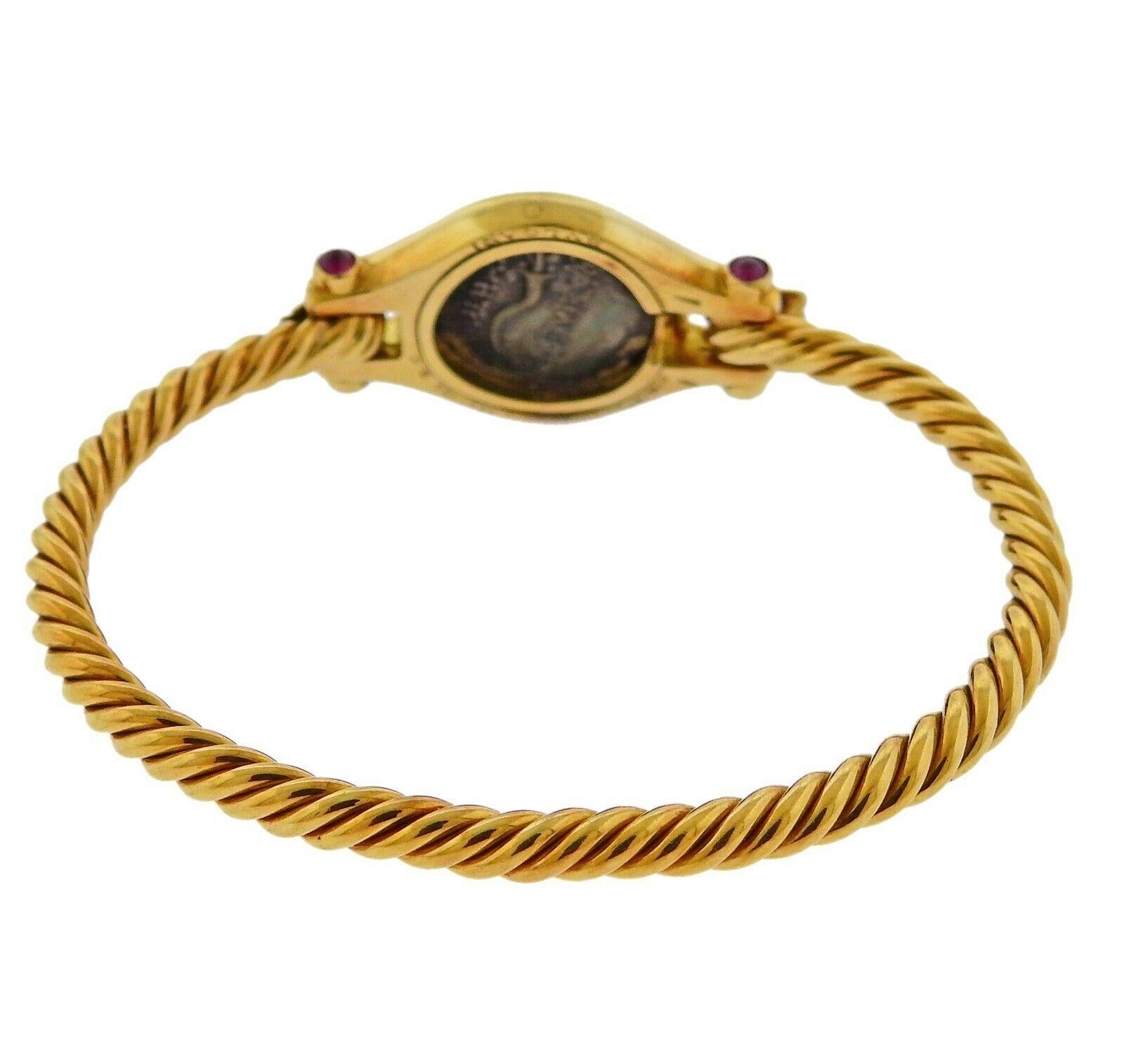 18k yellow gold bracelet by Bvlgari, set with an ancient coin, surrounded by ruby cabochons. Bracelet will fit approx. 7