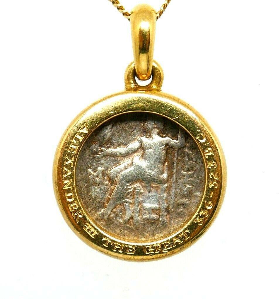 Bulgari ancient Greek coin charm pendant. The coin is a silver tetradrachm framed in 18k yellow gold. Writing on a rib: 