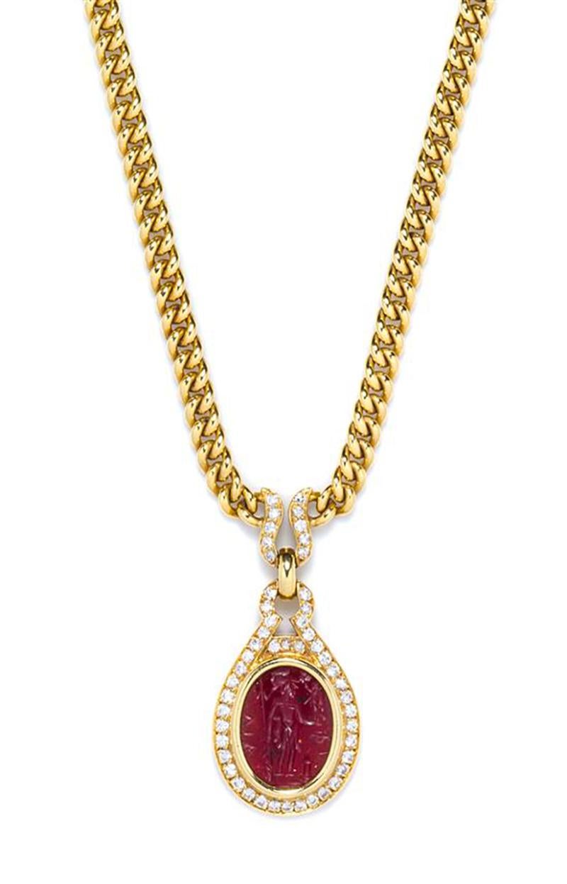 An 18 Karat Yellow Gold, Ancient Intaglio and Diamond Necklace by Bulgari,
consisting of a pendant containing an oval carnelian intaglio from the second century B.C. depicting the goddess Minerva set within a bezel setting and hinged bail