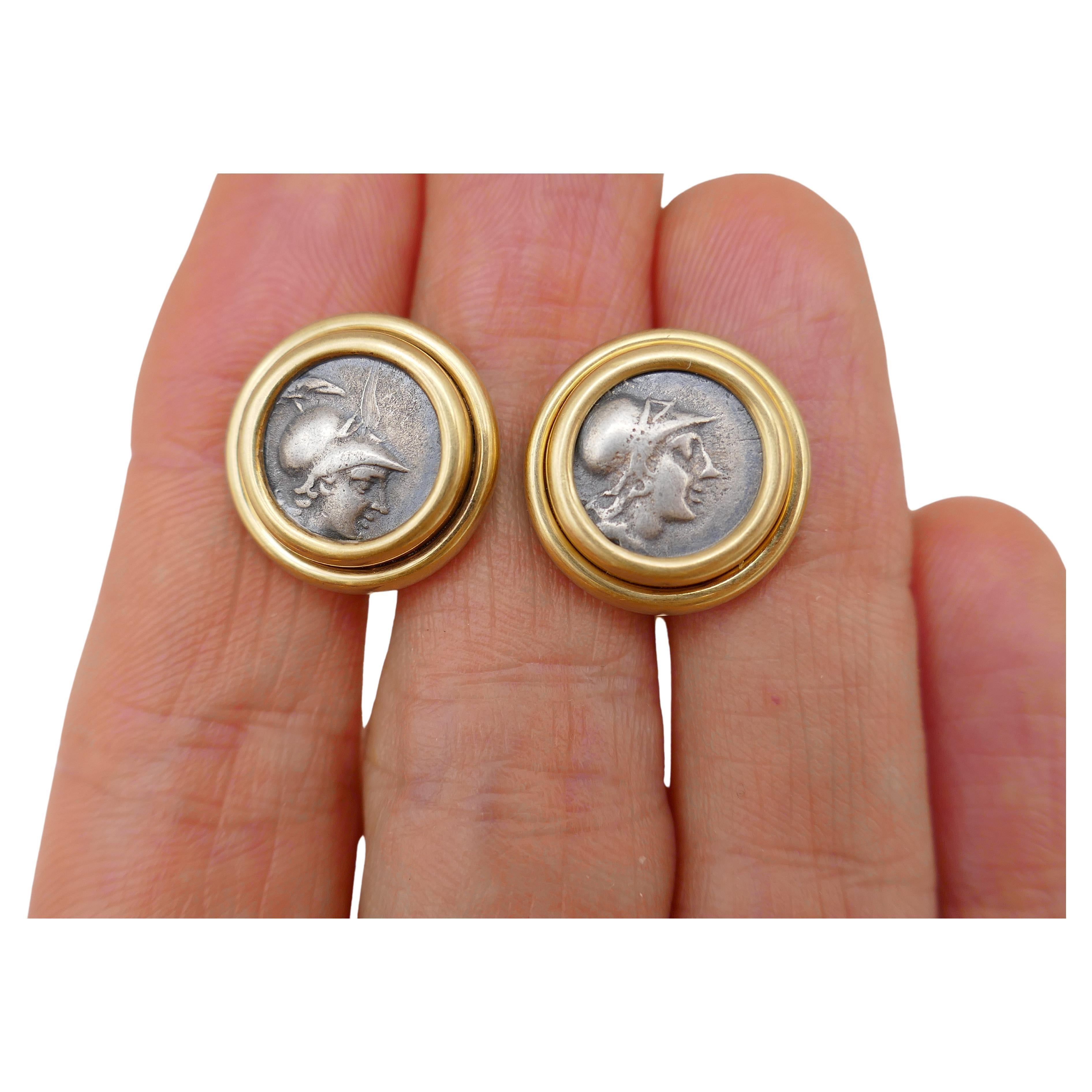 A pair of vintage cufflinks by Bulgari, made of 18k yellow gold featuring ancient Roman coin. 
The coins are silver, double bezel set. They are from 2nd century B.C., which make them 2,300 year old.
The cufflinks stamped with 