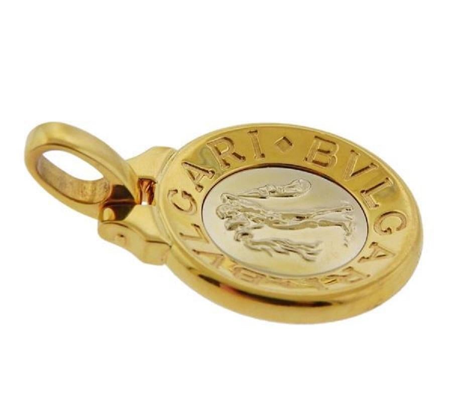 Bvlgari 18k two tone gold Aquarius Zodiac pendant.  Pendant is 25mm in diameter x 37mm long with bale. Weight is 18.4 grams. Marked  Bvlgari, 750, made in Italy.
