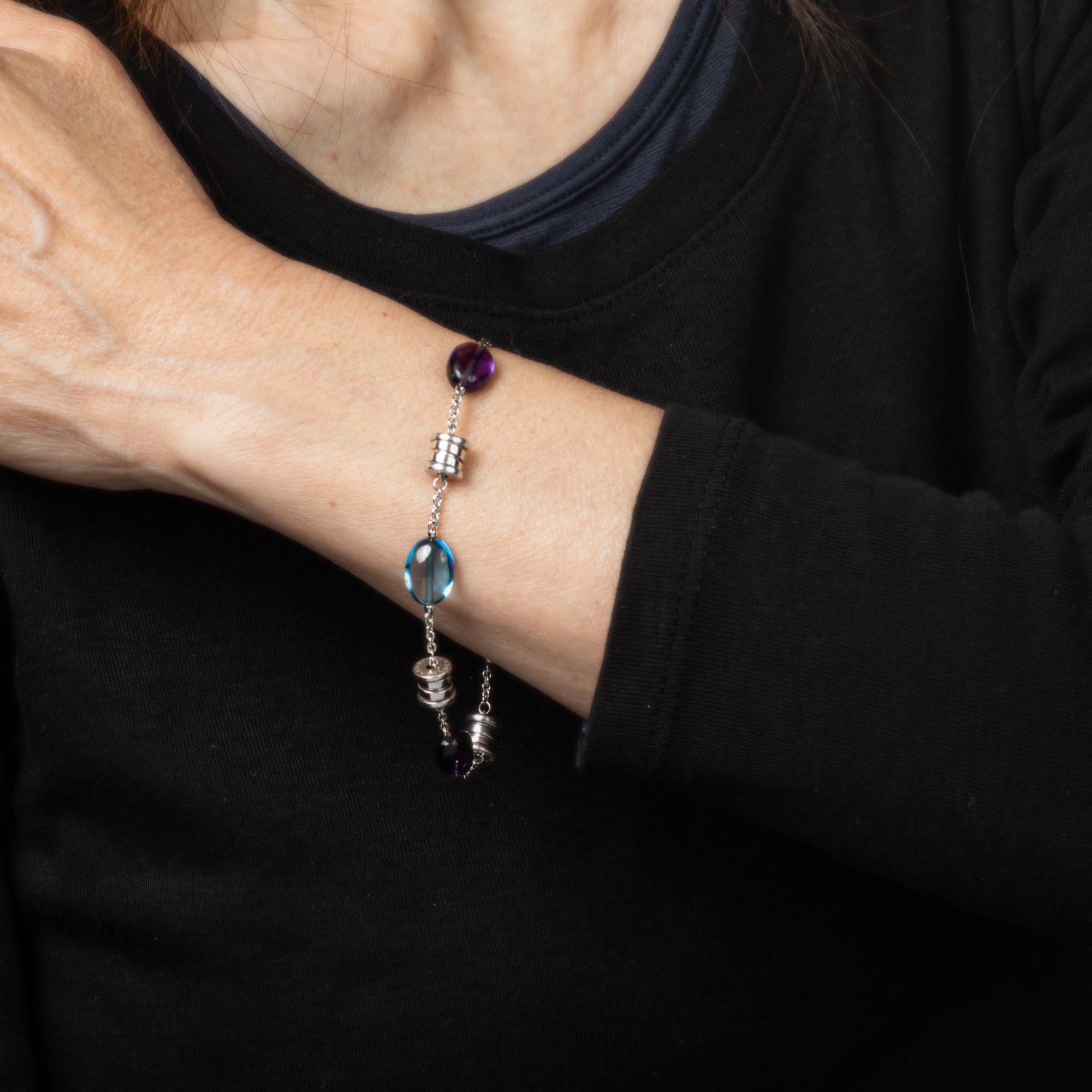 Pre-owned Bulgari B Zero amethyst & blue topaz bracelet crafted in 18 karat white gold.  

Blue topaz & amethyst beads measure 11.5mm x 8mm (in very good condition and free of cracks or chips).

The Bulgari bracelet features bright blue topaz and