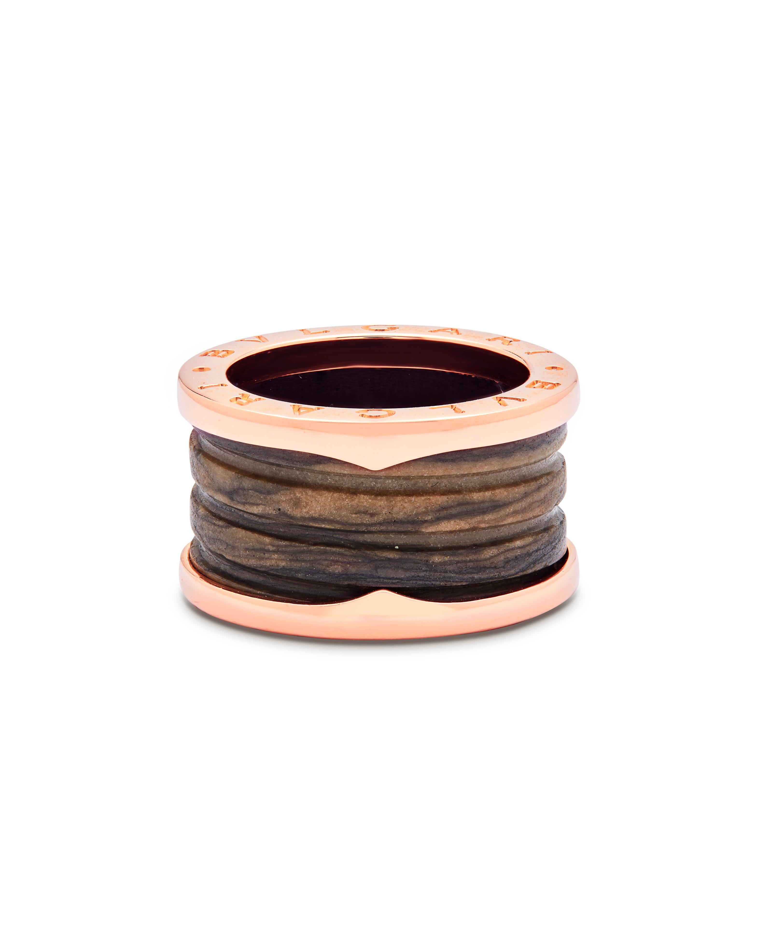 This iconic Bulgari capsule collection has become one of the most iconic, limited collections ever made by the Maison. 

Set in Rose gold and inlaid with a central piece of Dark brown marble and Bvlgari’s iconic stamp on the side. The marble is