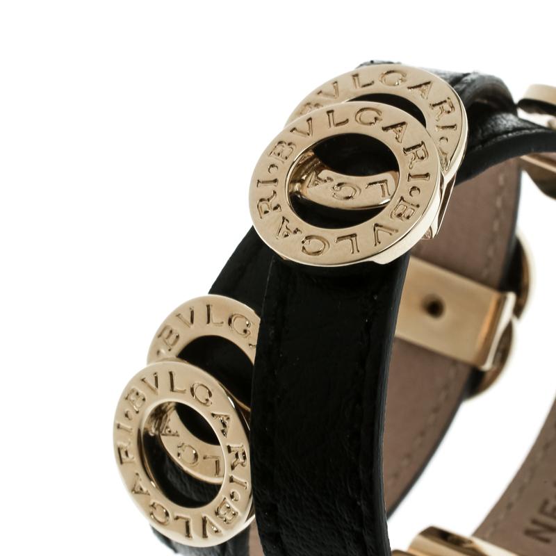 This bracelet from Bvlgari exudes style and chicness. Subtly designed in a doubled coil wrap style with black leather, the bracelet is accented by gold-tone interlocking rings, engraved with the brand's name. A push clasp completes this lovely