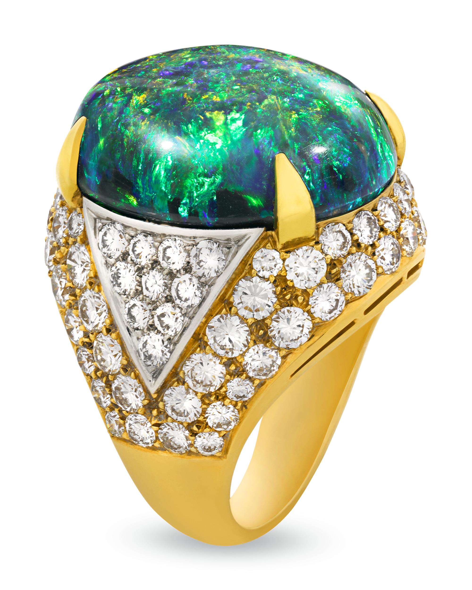 Dynamic beauty and exceptional color permeate the approximately 20.00-carat lightning ridge black opal in this sculptural ring from Bulgari. Displaying a kaleidoscopic range of cool green, red and blue hues, the opal is accented by glittering white