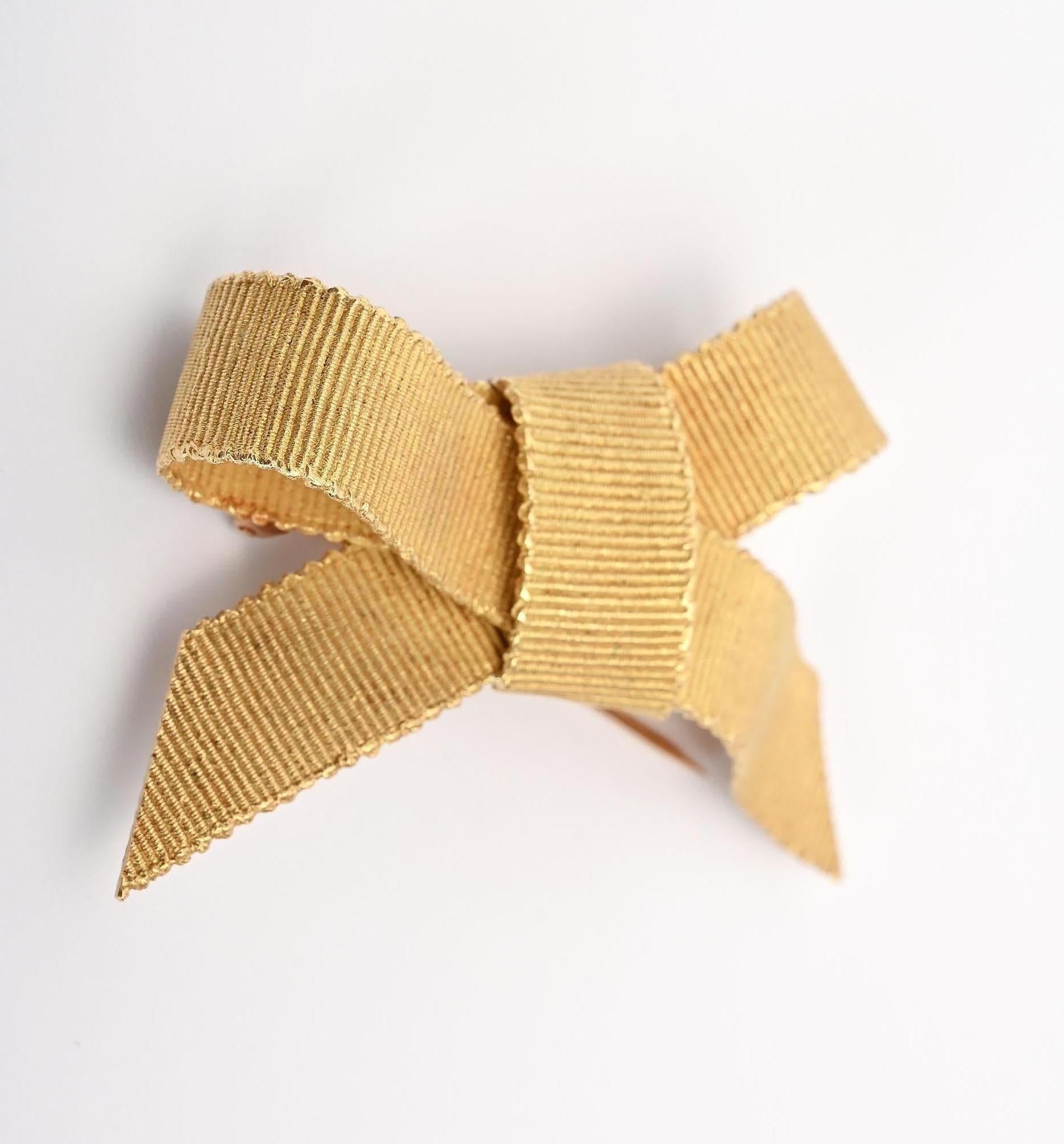 Exquisitely detailed  Bow brooch by Bulgari in which the 18 karat gold is finely textured to look like grosgrain ribbon.  The brooch is 2 3/4 inches wide and 1 1/2