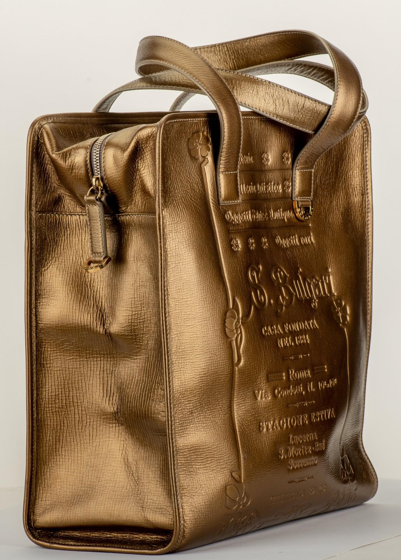 Bulgari mint condition large bronze leather shopper with gold tone hardware. Comes with booklet and original dust cover.