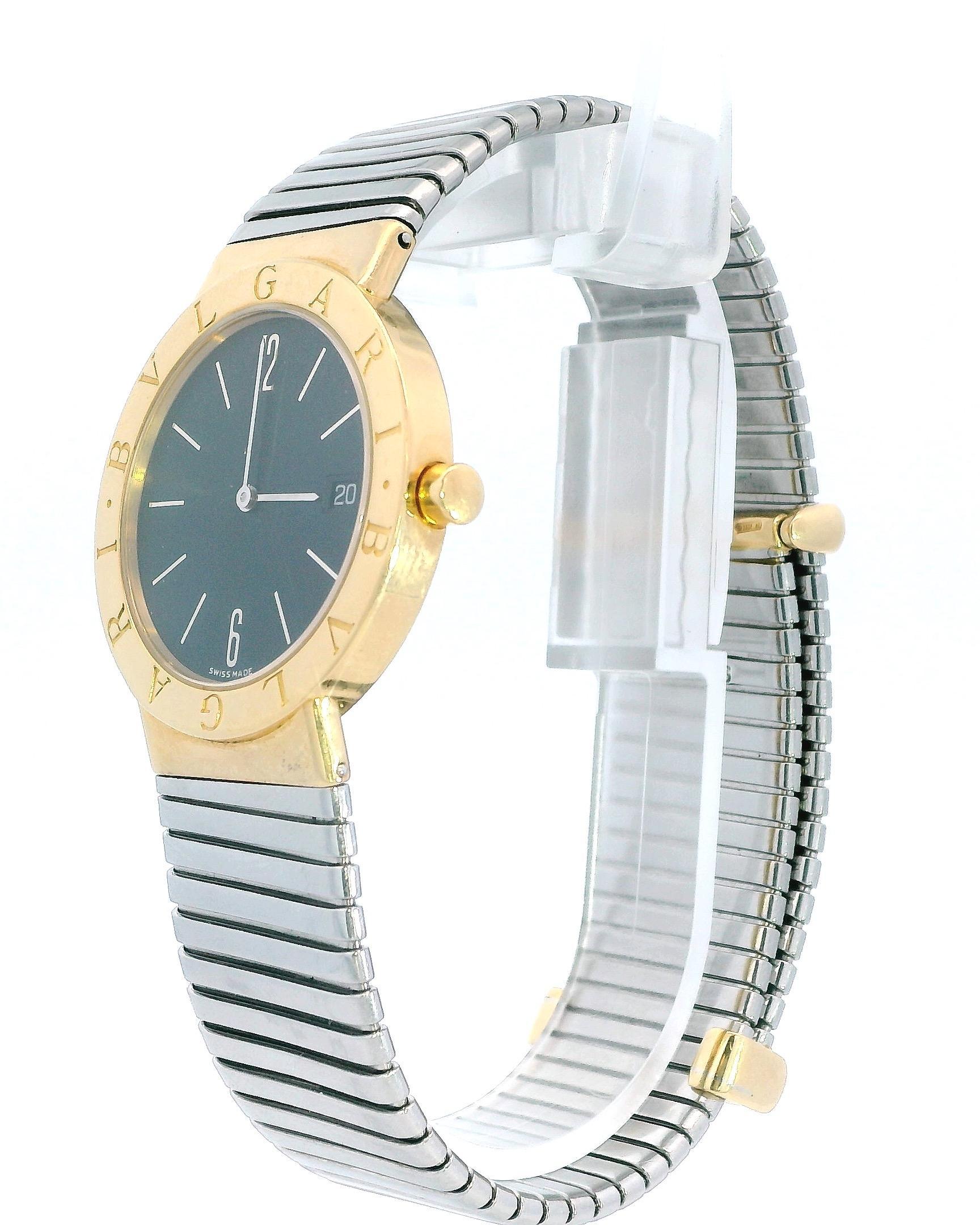 Bvlgari Tubogas BB33GSCD. 33mm 18K yellow gold case. 18K yellow gold fixed bezel with engraved Bvlgari. Black dial with silver tone hands and index and Arabic 6 & 12-hour indicators. Date window at 3 o'clock position. 18K yellow gold loops and