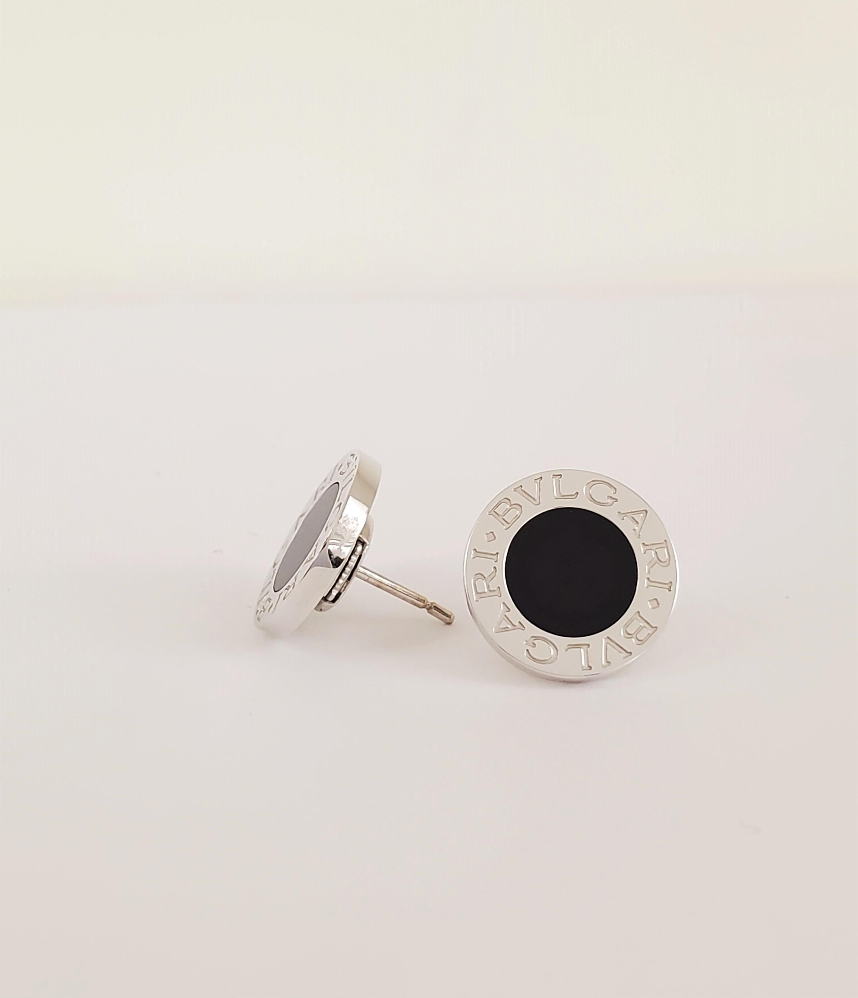 Authentic Bulgari earrings crafted in 18 karat white gold and featuring a round onyx center.  The earrings measure 1/2 inch wide.  Signed Bulgari, 750, Made in Italy, with serial number.  Earring backs are also stamped Bulgari, 750, Made in Italy.  