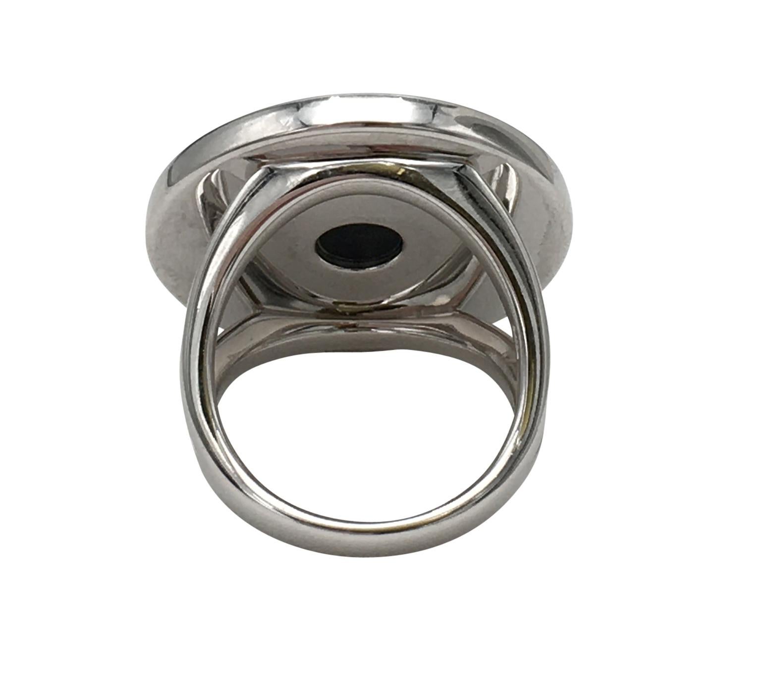 Authentic Bulgari ring crafted in 18 karat white gold featuring a round onyx disk at the center.  The onyx disk measures 16mm while the ring itself measures 24mm.  Size 52 (US size 6). Signed Bulgari, 750, Made in Itlay, 52.  The ring is accompanied
