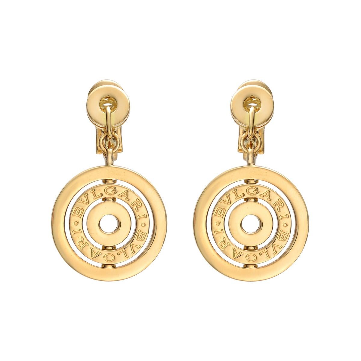 A chic set of authentic Bulgari earrings showcasing the iconic circular motif engraved with Bvlgari Bvlgari in 18k yellow gold. The earrings measure 1.37