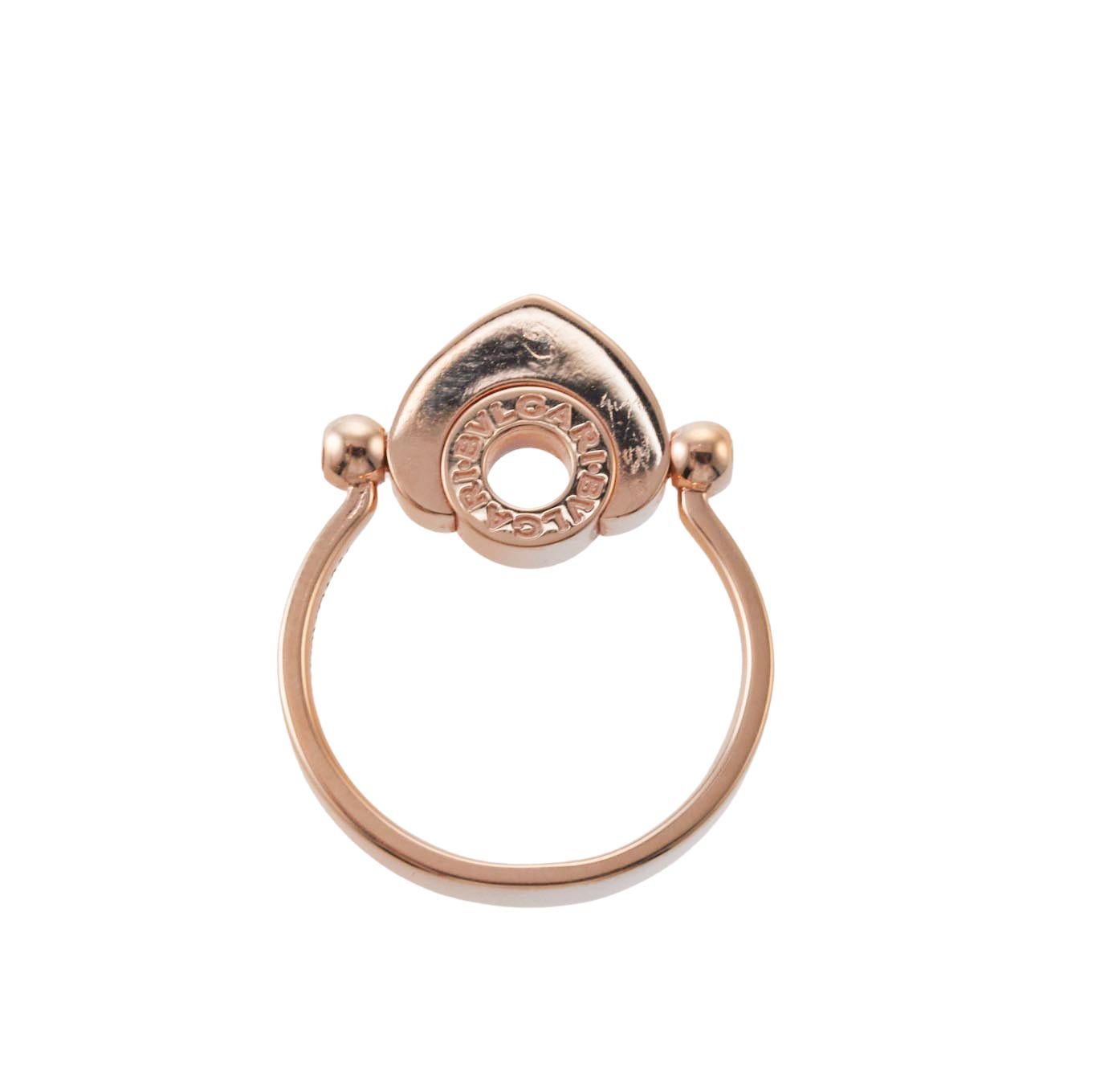 18k rose gold mother of pearl heart flip ring by Bvlgari. Top of the ring measures 17mm x 12mm, Ring comes in following sizes: 52; 53; 55. Marked: AU 750, Made in Italy, Bvlgari, Size and Serial Number. Weight is 5.0 grams. 