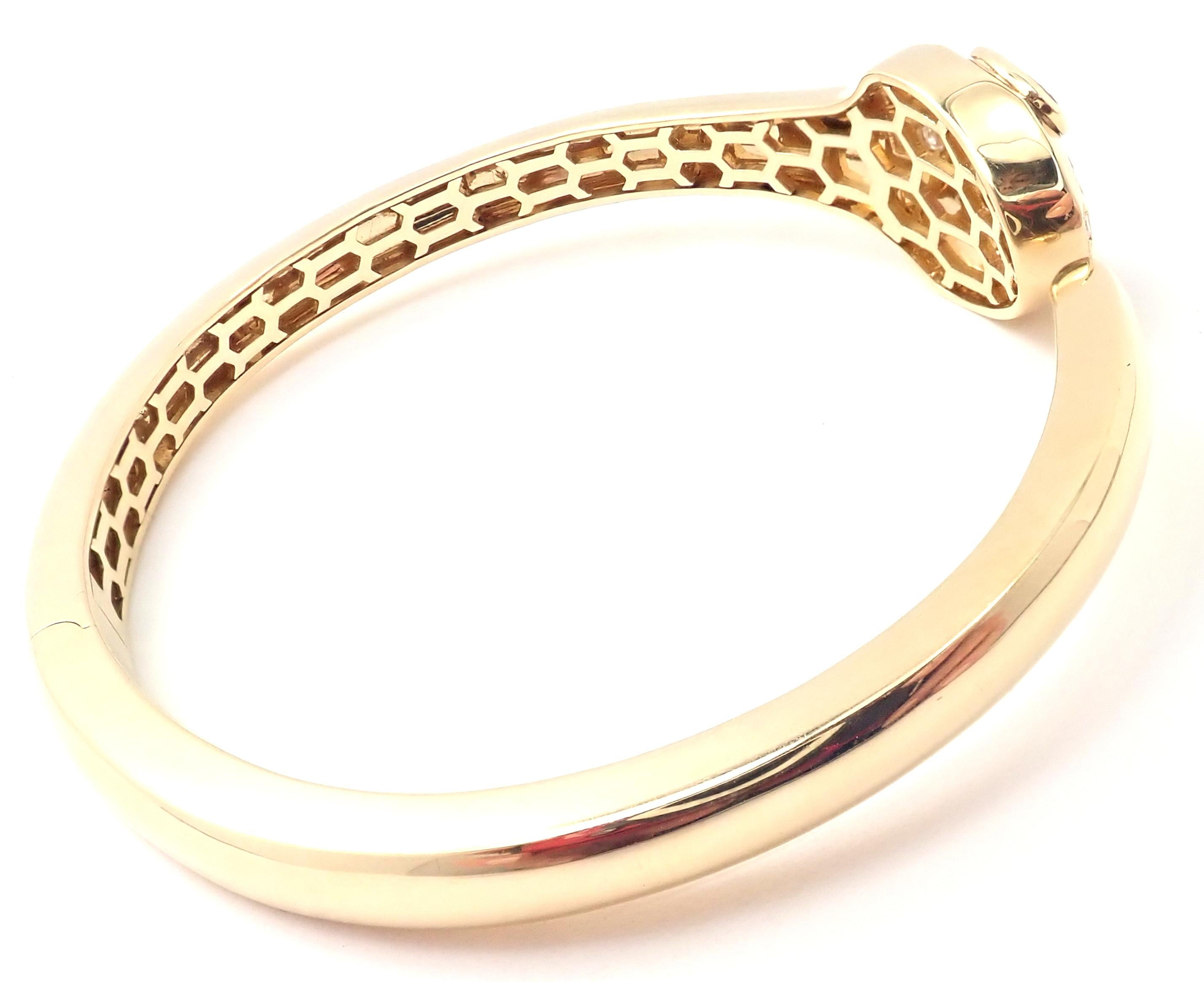 18k Yellow Gold Diamond Rubellite Serpenti Snake Bangle Bracelet by Bulgari. 
With 18 round brilliant cut diamonds VS1 clarity, E color total weight approx. .30ct
2 pear shape rubellite stones.
This bracelet comes with the box and