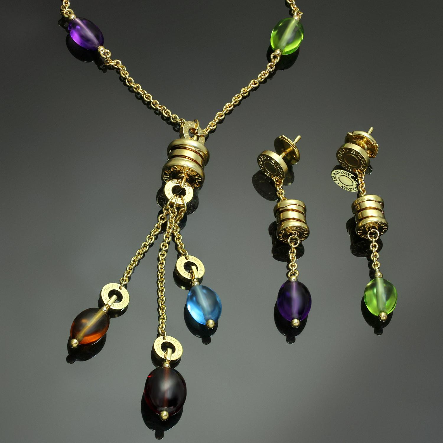 This gorgeous jewelry suite from Bulgari's iconic B.Zero1 collection features a drop necklace and a pair of drop earrings crafted in 18k yellow gold and set with a colorful array of cabochon gemstones - peridot, rhodolite, garnet, amethyst, blue